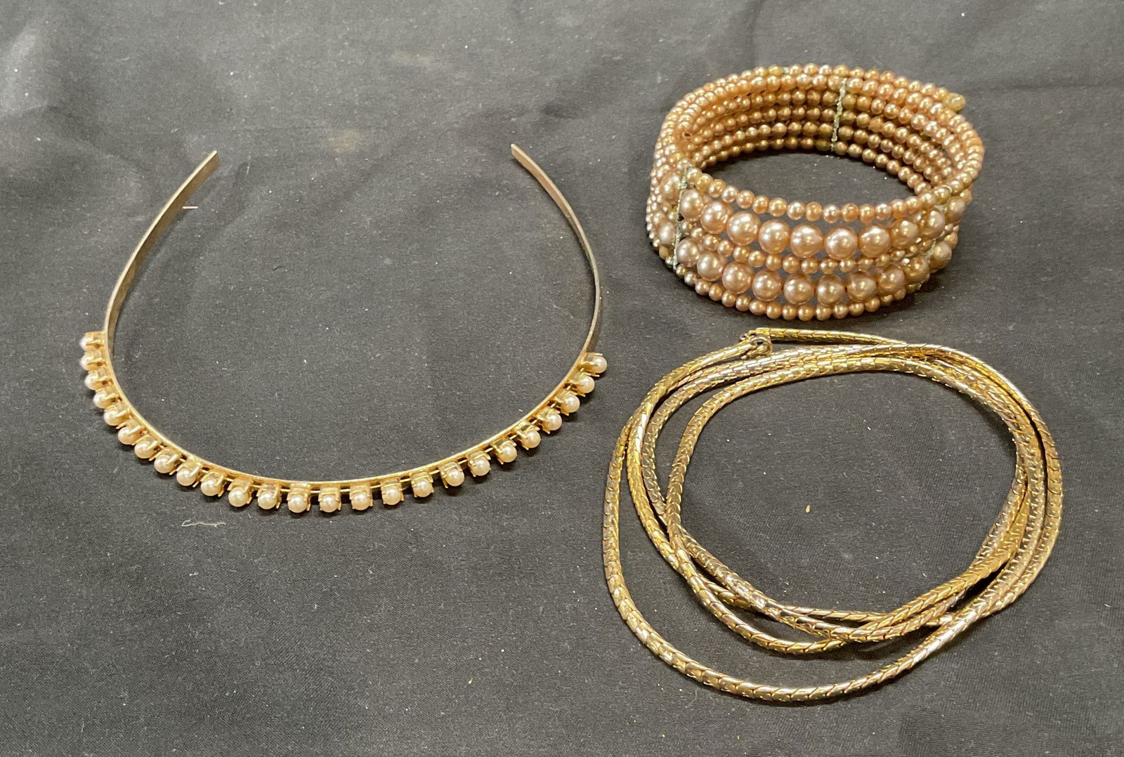 Lot 3 Gold Tn Faux Pearl Bracelet, Headband +: Lot of 3 pieces. Gold tone and faux pearl headband, faux pearl beaded bracelet, and gold tone chain necklace. Necklace drop length approx. 21 inches. Bracelet approx. 2.75 inches wide. Headband approx