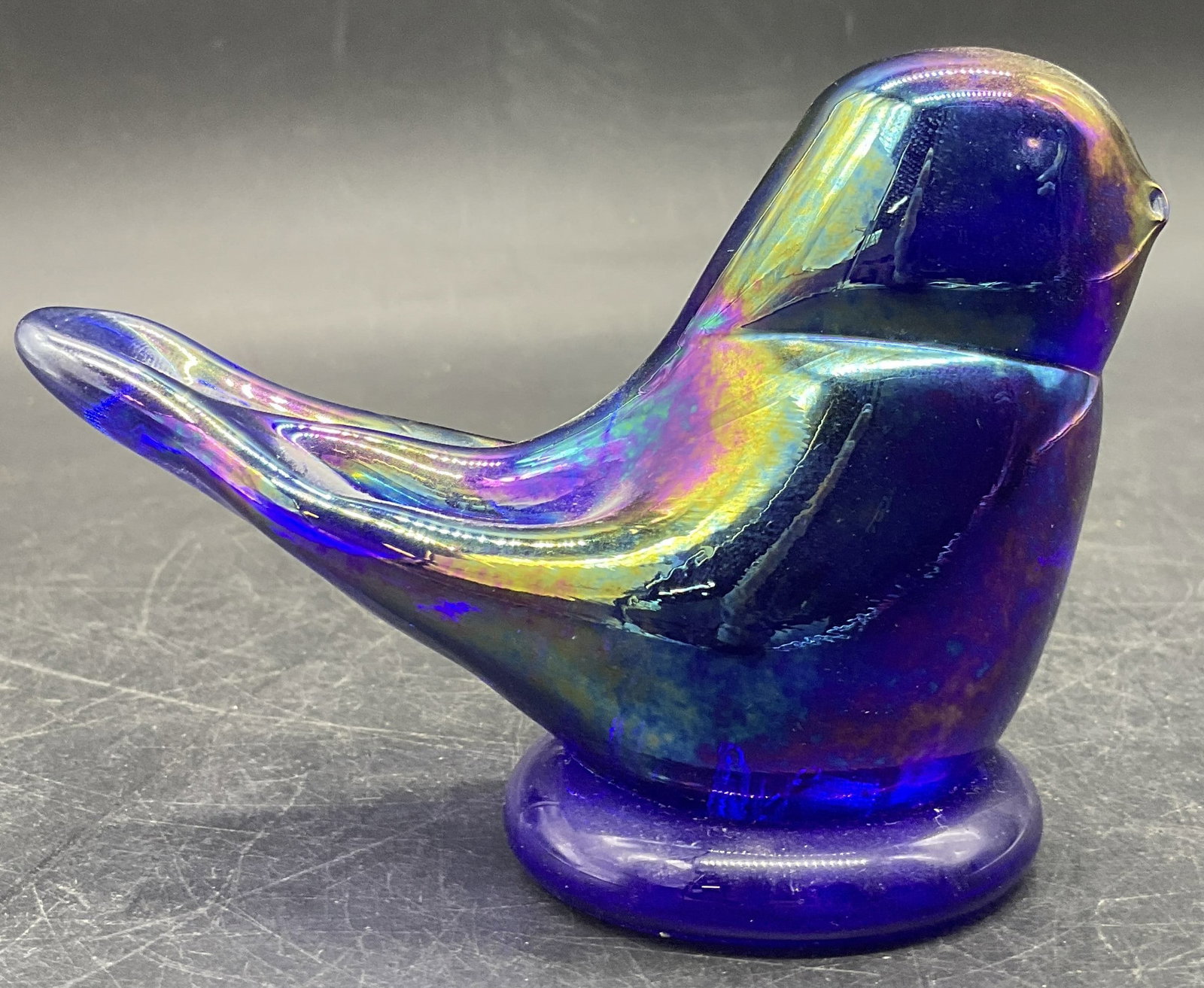 LEO WARD 2002 Signed Carnival Glass Bird Figural: Iridescent carnival glass bird figural. Underside signed LEO WARD 2002. Measures approx. 3H x 4W in. Some surface wear consistent with age, use, and exposure. home decor, home accents, homewares, hous