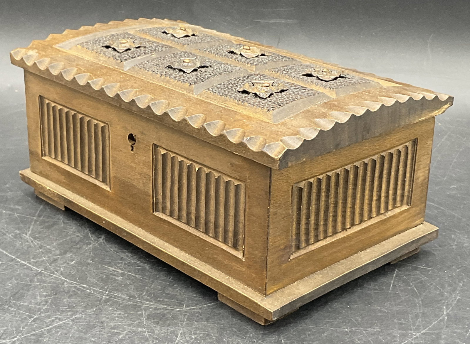 Vintage Metal Accent Carved Wood Hinged Box: A vintage carved wood box with metal accents to the lid. Box opens with hinge hardware. Measures approx. 3.25H x 7.75W in. Some surface wear, chipping, and discoloration present. Residue present. Wood