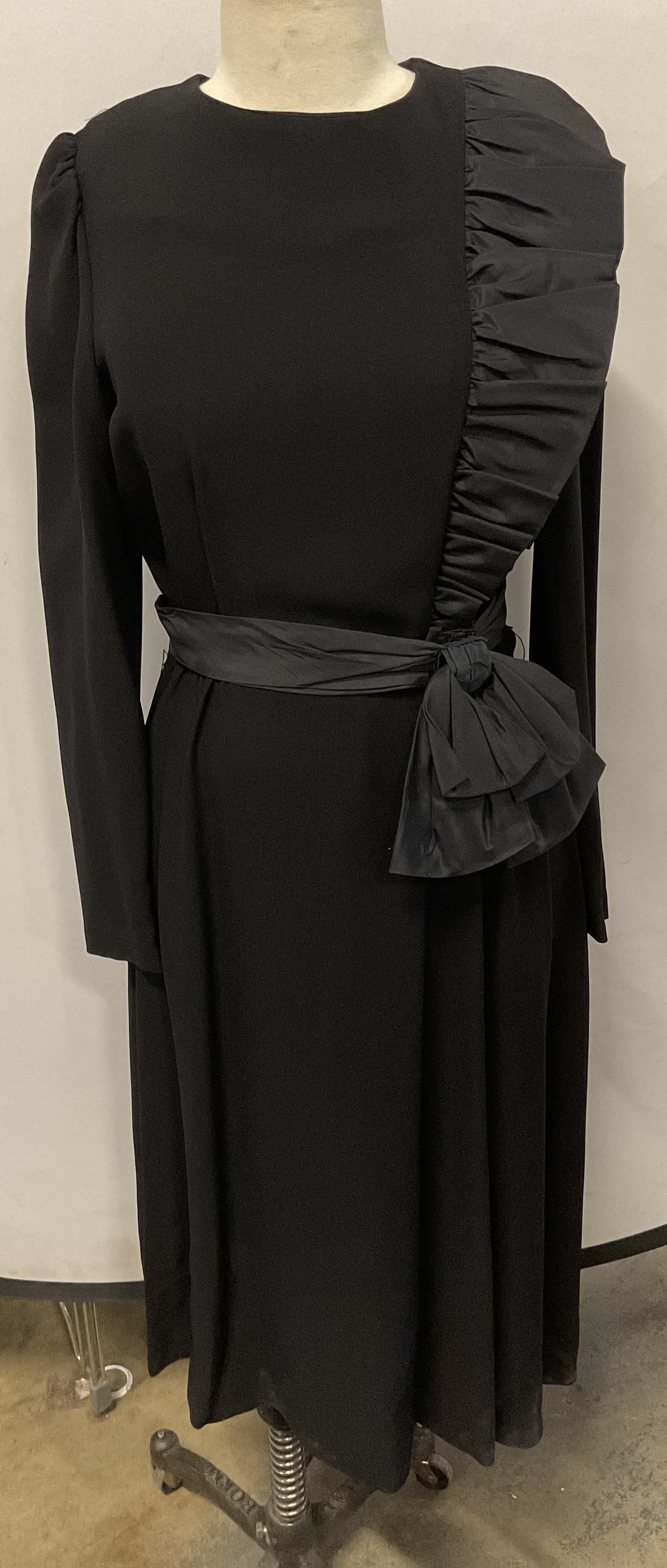 Vntg Lora Lang Black Ruffle Bow Belted Dress: Vintage Lora Lang black long sleeve dress with ruffle detail on chest and belt with oversized bow. Measures approx. 18.5 inches across chest. Marked size 10. Synthetic material. Some wear to material 