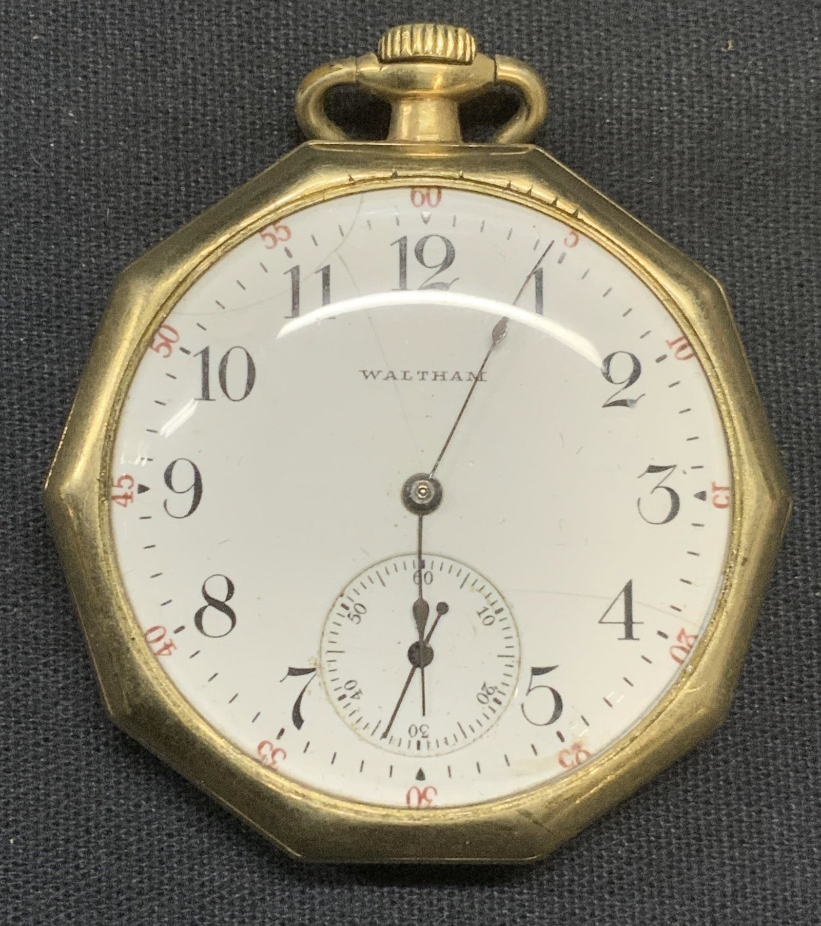 Antique Waltham Gold Filled Pocket Watch: Antique Waltham gold filled pocket watch. Geometric shaped with glass cover over face. Measures approx. 1.75 inches wide. Cover not attached. Not tested for function. Some surface wear including scrat