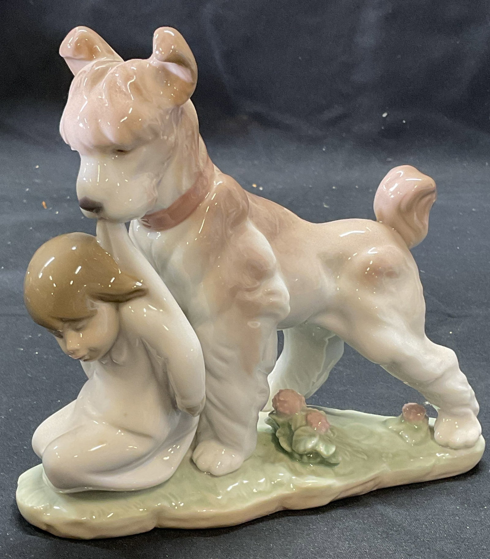 Lladro Porcelain Safe & Sound Figurine, Spain: Lladro porcelain figurine. Design number 6556 Safe and Sound. Figure of a boy and dog. Trademarked to underside. Marked November 14 Event Figurine. Made in Spain. Measures approx. 6 x 2.5 x 5.75 inche