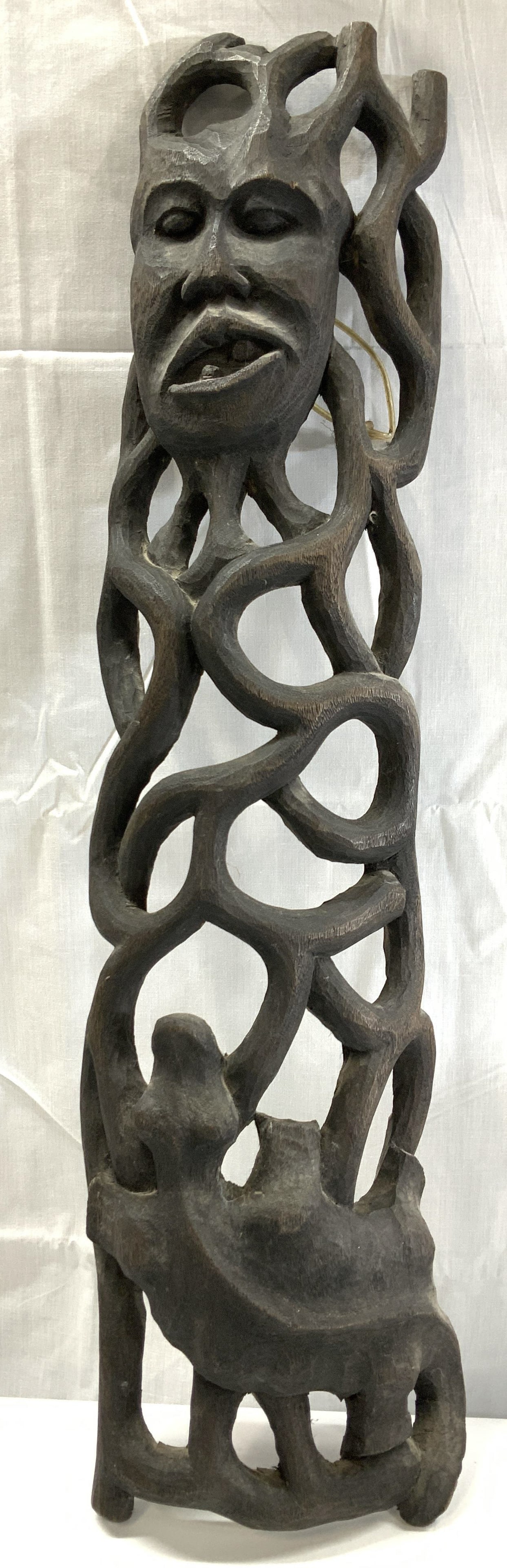Handmade Wood Tribal Sculpture, Haiti 2ft: Hand carved wood wall sculpture of a climbing reptile toward a face with openwork branches. Signed on paper on verso, reads Created by Ralph, Handmade in Haiti . Measures 24 in. Tall x 7 in. Wide., De