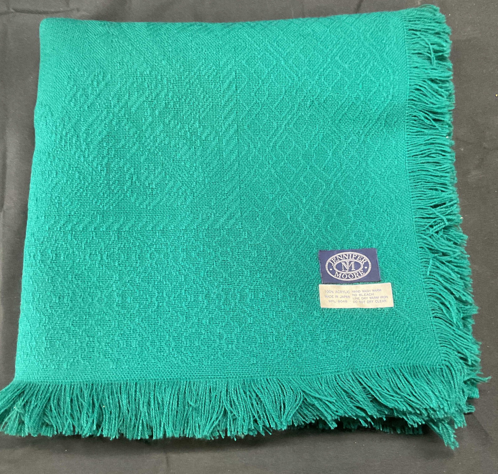 Jennifer Moore Teal Fringe Scarf: Jennifer Moore teal scarf with fringe trim and textured pattern design. 100% acrylic. Measures approx. 45 x 45 inches. Some wear to material including blemishes and pulls consistent with exposure. Jen
