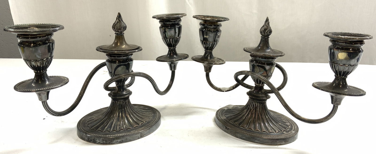 Silver Plated Pr 3 Arm Candelabras ENGLAND: Lot includes 2 candelabras. Each are inscribed ENGLAND. Candelabras each have 3 arms including centers. Each piece is silver plated. Candelabras each measure approximately 10.25 inches wide 6.5 inches
