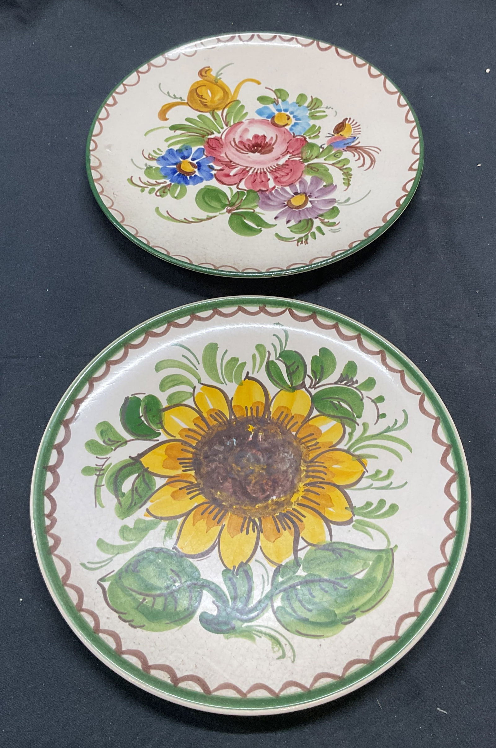 Lot 2 Vintage Ulmer Keramik Floral Plates: Lot of 2 vintage Ulmer Keramik ceramic floral plates. Hand painted. Trademarked on undersides. Measure approx. 7.75 inches wide. Both pieces have some surface wear including scratching and crazing obs