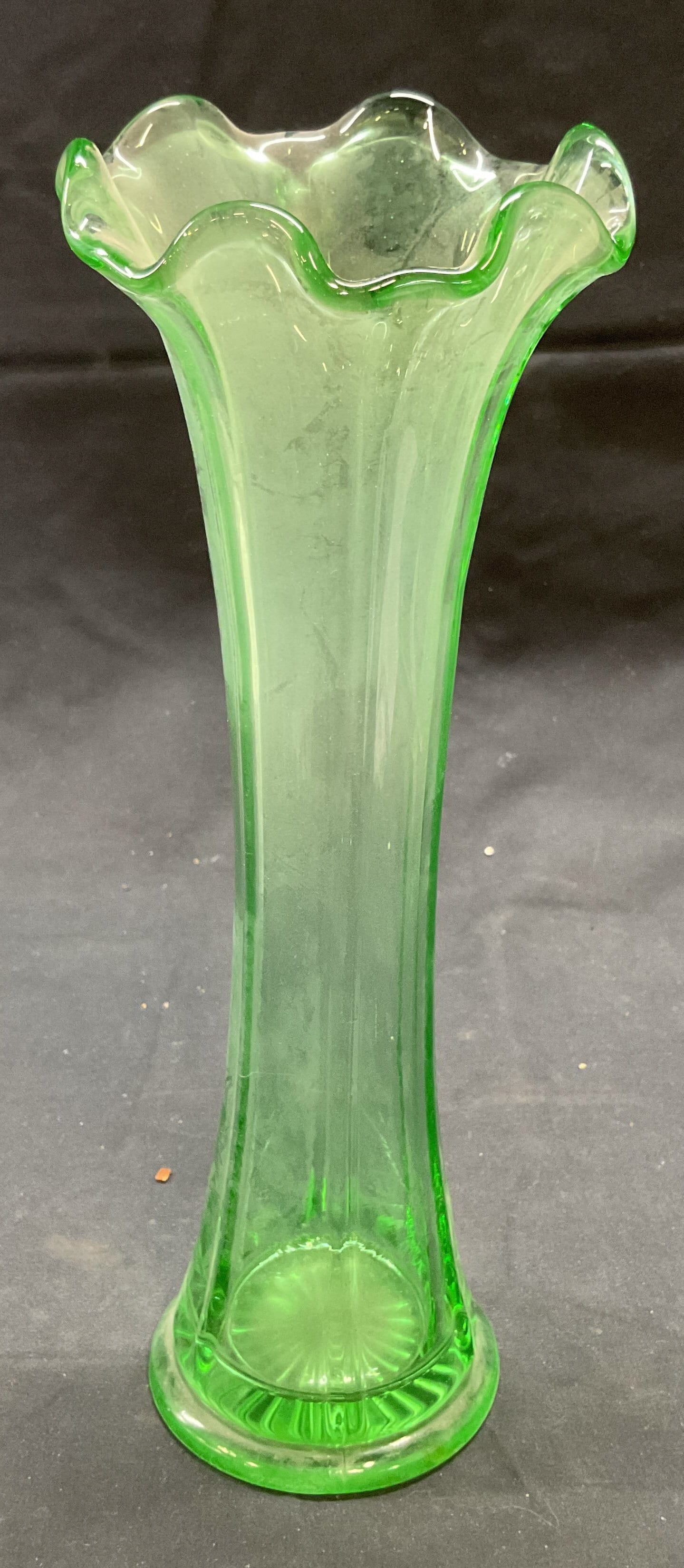 Vintage Uranium Glass Handkerchief Vase: Vintage uranium glass vase with handkerchief rim. Green glass, fluoresces under UV light. Measures approx. 3.75 x 10 inches. Some surface wear including scratching observed. Uranium glass, uranium gla