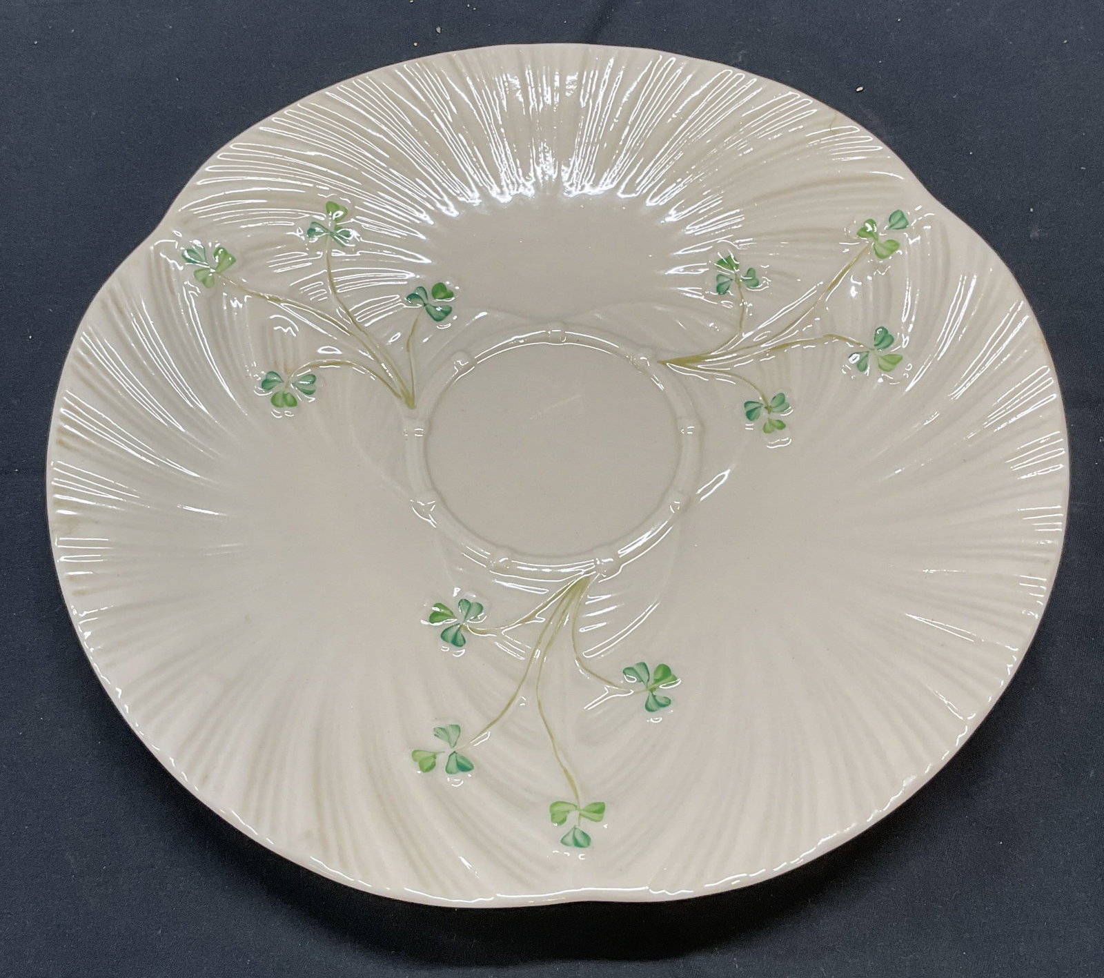 Vintage BELLEEK China Shamrock Plate Ireland: Vintage BELLEEK China plate with raised swirl pattern and hand painted shamrock motif. Trademarked to underside, made in Ireland. Measures approx. 9.25 inches wide. Some surface wear consistent with e