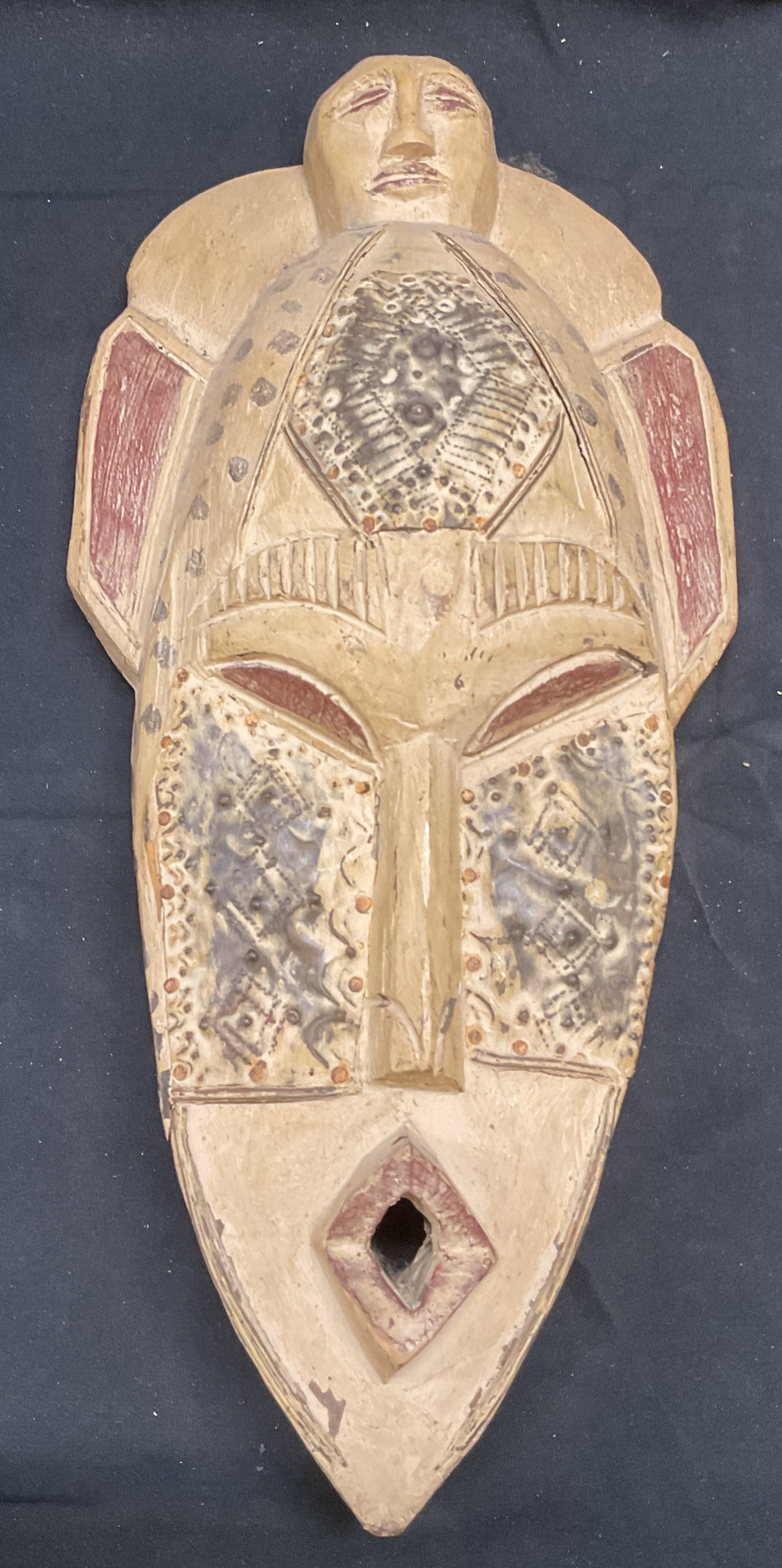 Hand Carved Wood African Tribal Mask: Hand carved wooden African tribal mask. Hand painted. Measures approx. 15.5 x 7.5 inches. Some surface wear including scratching and chipping observed. Mask, African mask, wood mask, tribal mask, deco