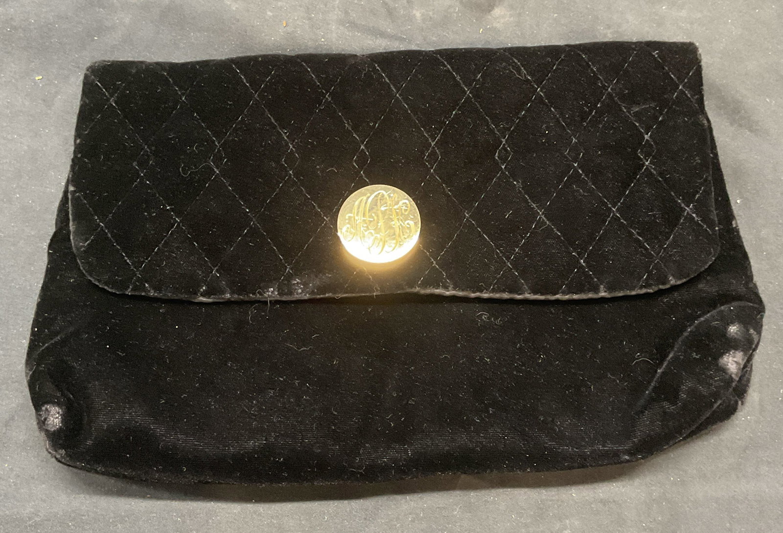 Vntg Elizabeth Arden Black Velvet Clutch: Vintage Elizabeth Arden quilted black velvet clutch. Gold tone hardware with monogram APH. Measures approx. 9.5 x 6 inches. Some wear to material consistent with exposure. Elizabeth Arden, Elizabeth A