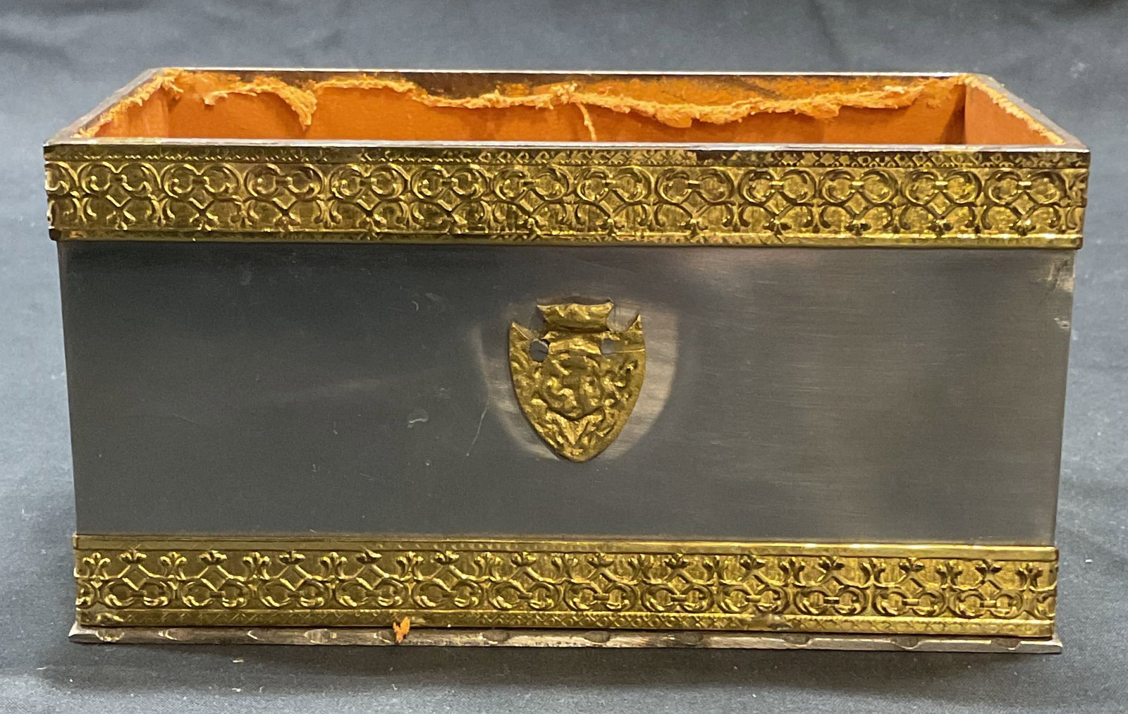 Vintage Silver & Gold Tone Shield Box: Vintage silver tone box with raised gold tone scroll border and shield motif. Leather lining. Piece has weight. Measures approx. 6.25 x 3.25 x 3.25 inches. Surface wear including scratching and losses