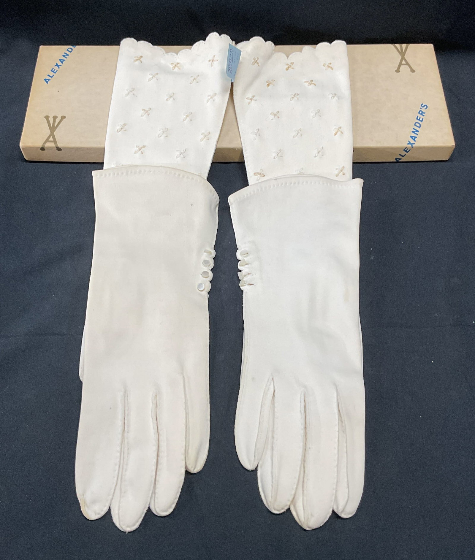 Lot 2 Vntg Van Raalte White Cotton Gloves +: Lot of 2 pairs of vintage white cotton gloves. Van Raalte gloves with floral embroidery. New with tag. Gloves with mother of pearl buttons, signed illegibly. Longer pair measure approx. 11.5 inches lo