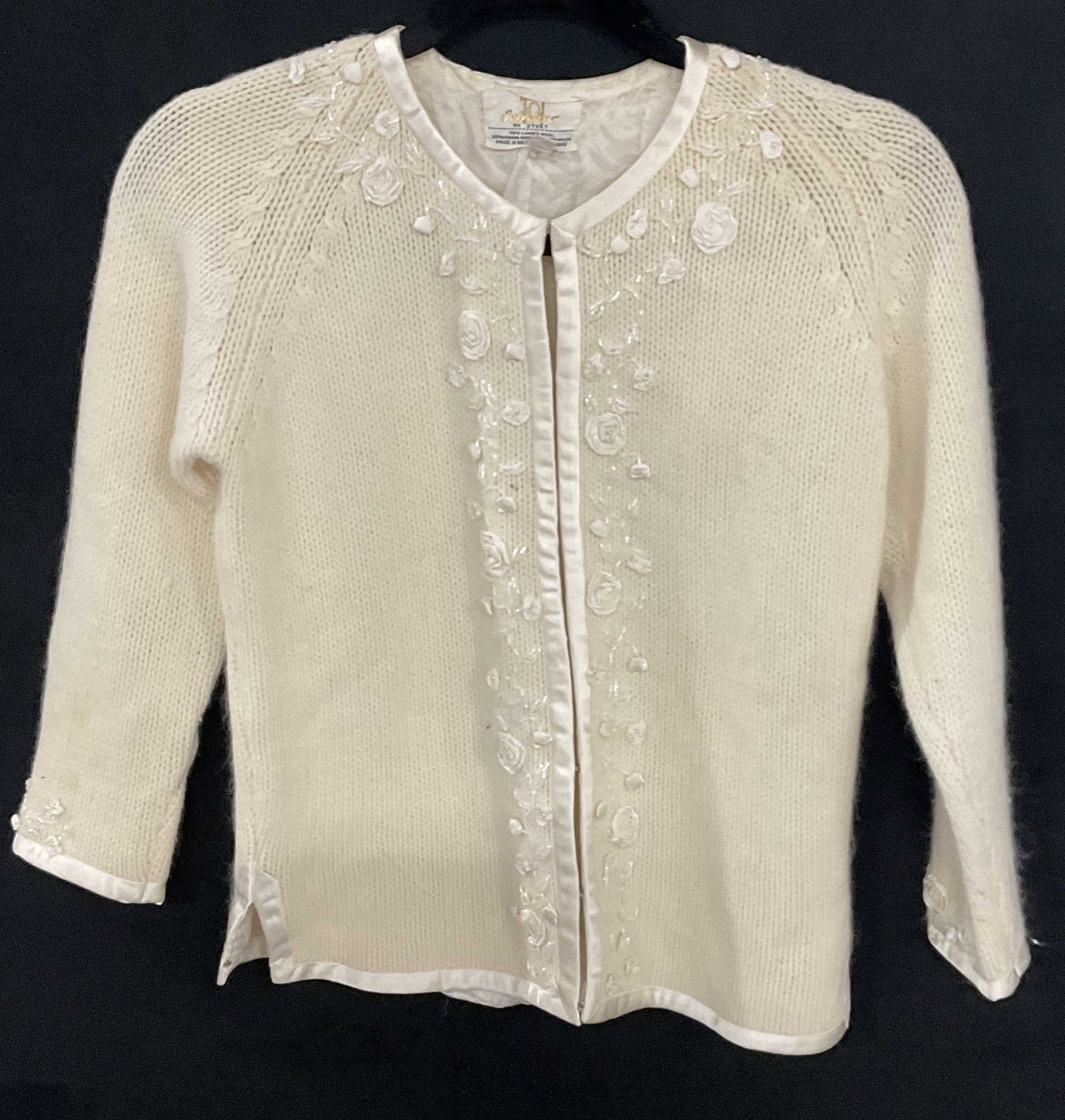 CYN LES Vintage Lambs Wool Blend Sweater HongKong: Cream hued vintage lambs wool blend sweater. Decorated with florals and seed beads. Metal clasp closures to the obverse. Brand tag reads CYN LES, 70% Lambs Wool, 20% Angora Rabbit Hair, 10% Nylon. Mad