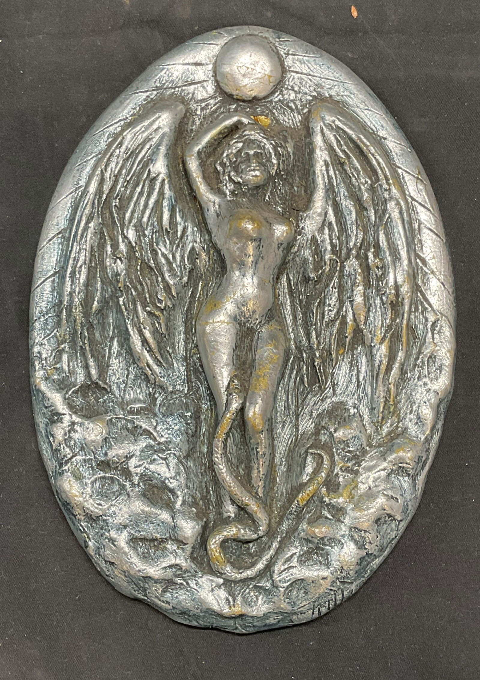 Silver Tone Nude Angel Figural Plaque: Silver tone over plaster wall plaque with raised nude angel and snake motif. Measures approx. 7 x 5 inches. Some surface wear including scratching observed. Angel figural, Angel plaque, wall plaque, w