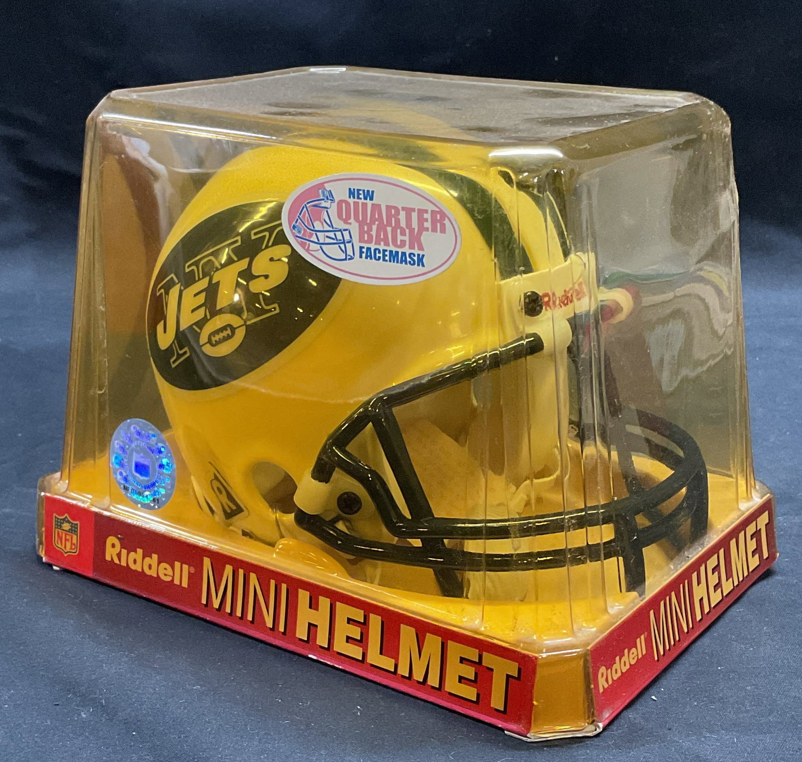 Riddell NY Jets NFL Mini Helmet NIP: Officially licensed NFL New York Jets mini helmet by Riddell. New in package. Measures approx. 5.5 x 7.5 x 5.5 inches. Some surface wear consistent with exposure. Property of Fifth Avenue, Manhattan, 
