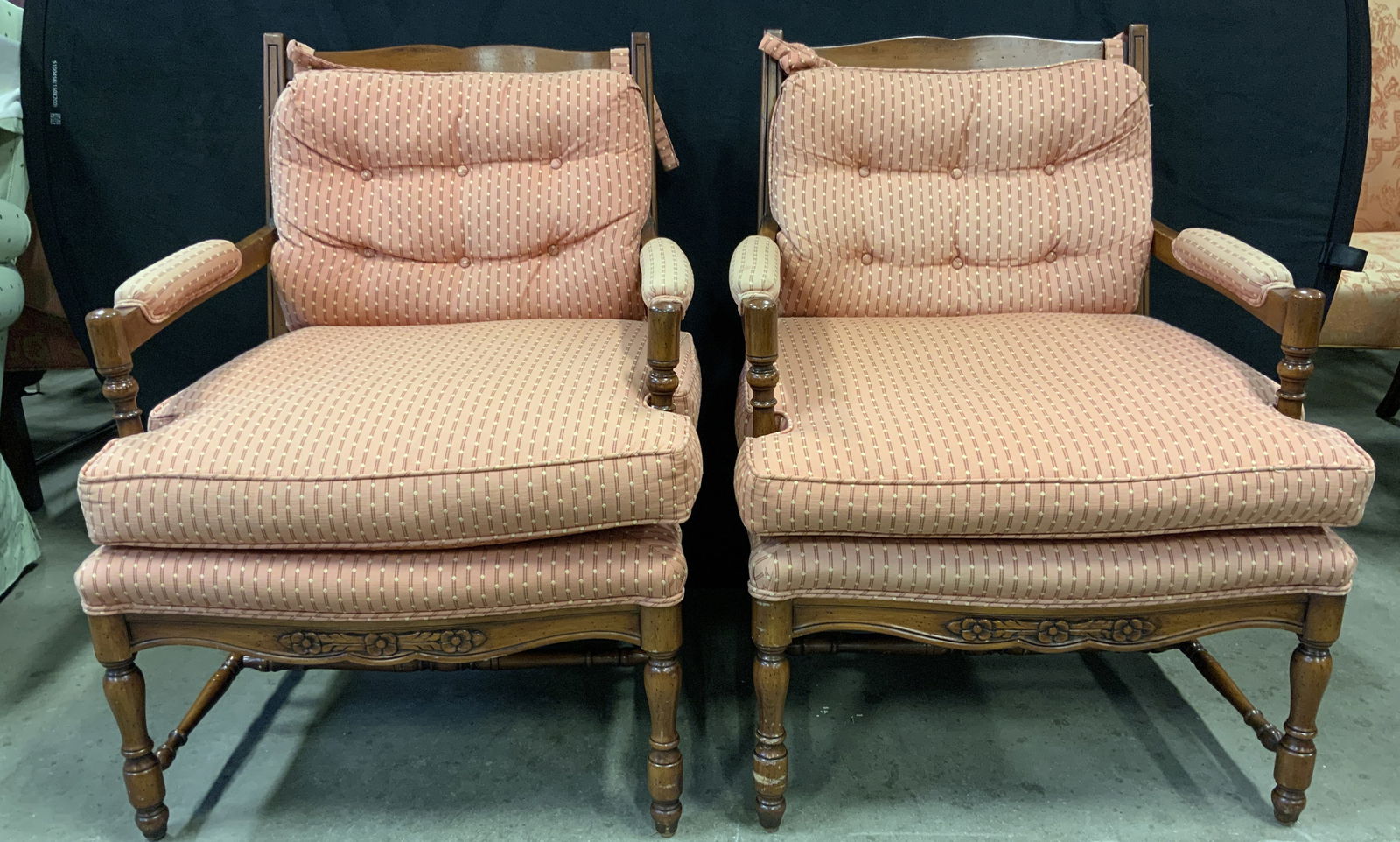 Pair Louis XV Bergeres Armchairs: Lot include 2 Bergeres armchairs. Each are Louis XV with tan toned wooden frames, tufted backrest cushions. Chair legs have stretchers in between. Areas of upholstery have double welting. Each measure