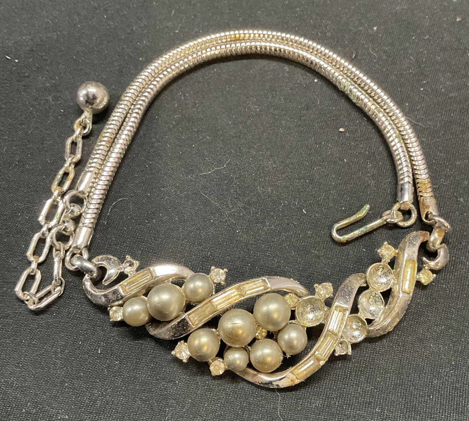 Vintage Silver Tn Crystal Faux Pearl Necklace: Vintage silver tone necklace with colorless crystal and faux pearl decoration. Drop length approx. 6.75 inches. Some surface wear including scratching observed. Some crystals and faux pearls need repl