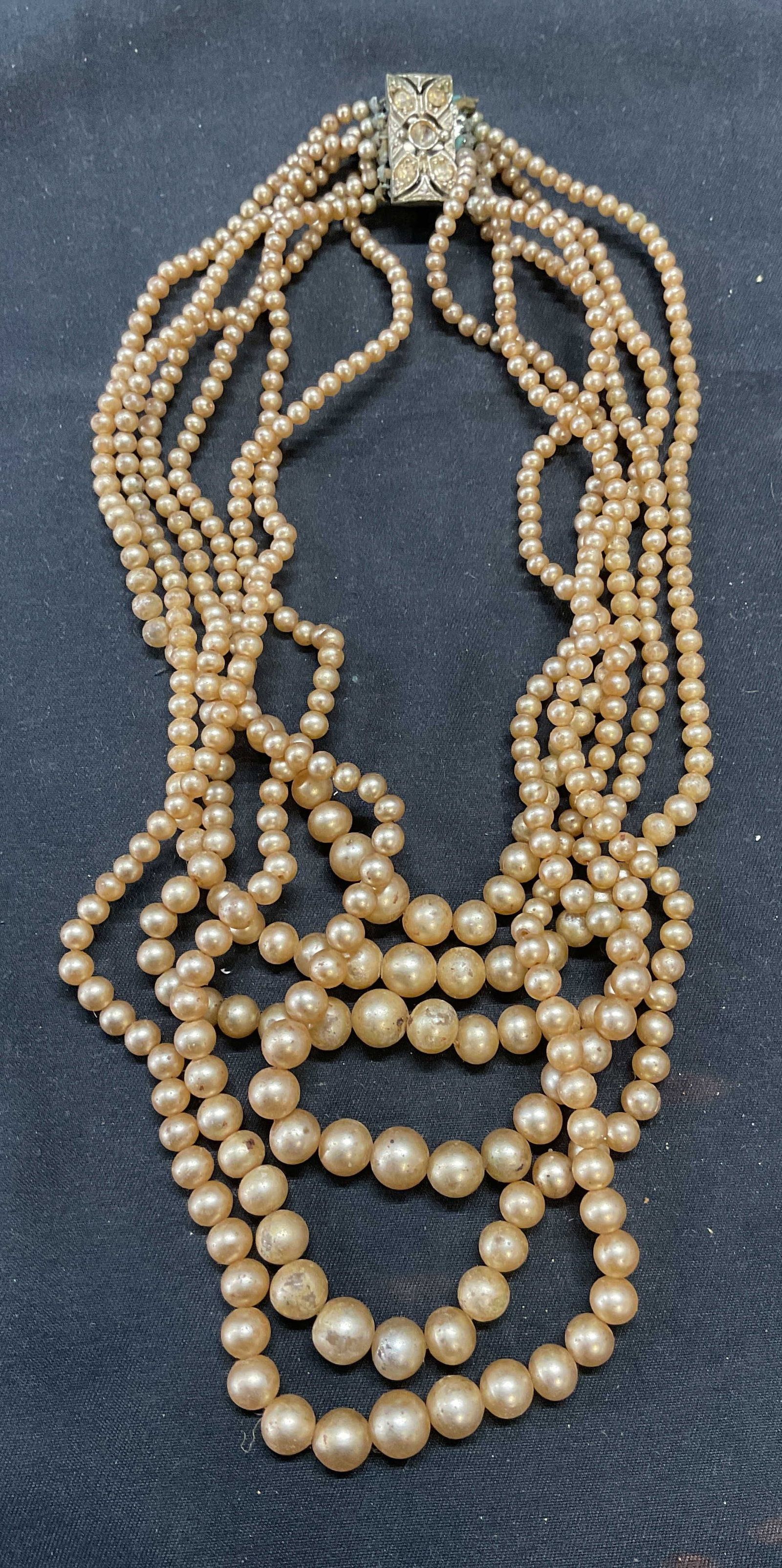 Vintage Faux Pearl Multi Strand Choker Necklace: Vintage faux pearl multi strand choker necklace with decorative silver tone crystal clasp. Drop length approx. 5.5 inches. Some surface wear including scratching observed. One crystal needs replacemen