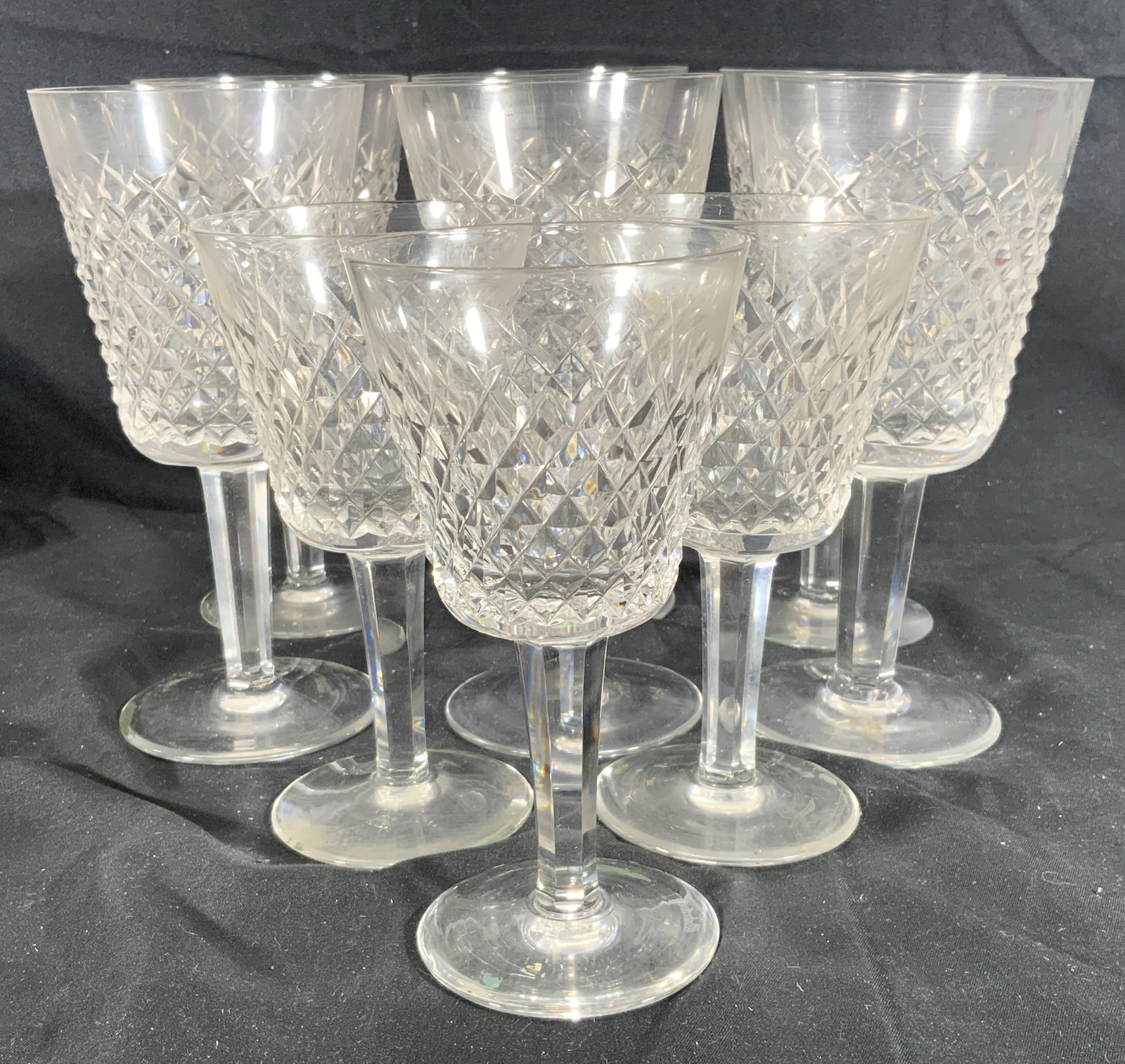 Lot 9 Waterford Crystal Alana Claret Wine Glasses: Lot 9 crystal wine glasses. Waterford Crystal Alana claret cut. Two groups, 6 larger glasses, and 3 smaller glasses. Underside of stem base has Waterford brand name. Larger glass measures approx. 7 H 
