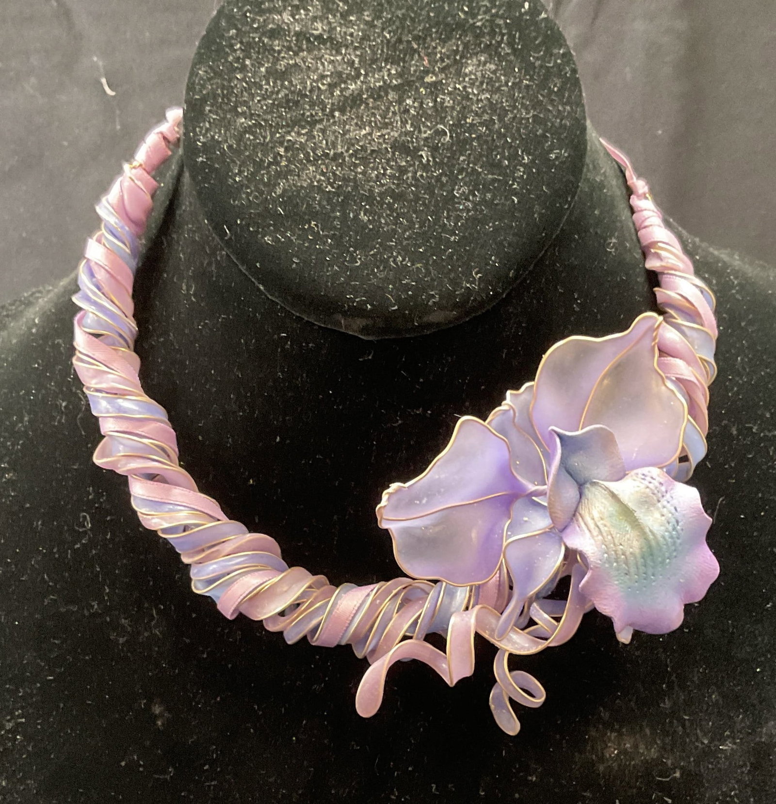 Vintage Purple Orchid Flower Choker Necklace: Vintage purple twisted band choker necklace with floral orchid pendant. Drop length approx. 6 inches. Composite material. Some surface wear including scratching observed. Jewelry, estate jewelry, cost