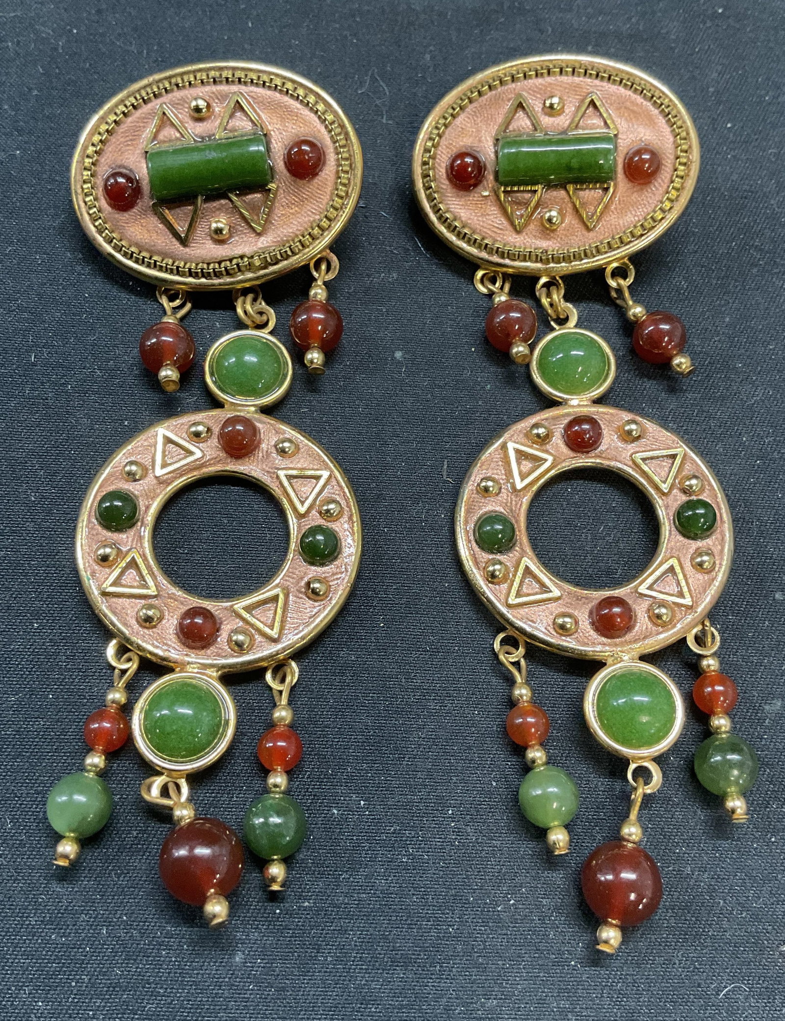 Vintage Gold Tone Faux Jade Earrings: Vintage gold tone earrings with faux carnelian and jade decoration. Post backing. Measure approx. 3.75 inches long. Some surface wear including scratching observed. Jewelry, estate jewelry, costume je