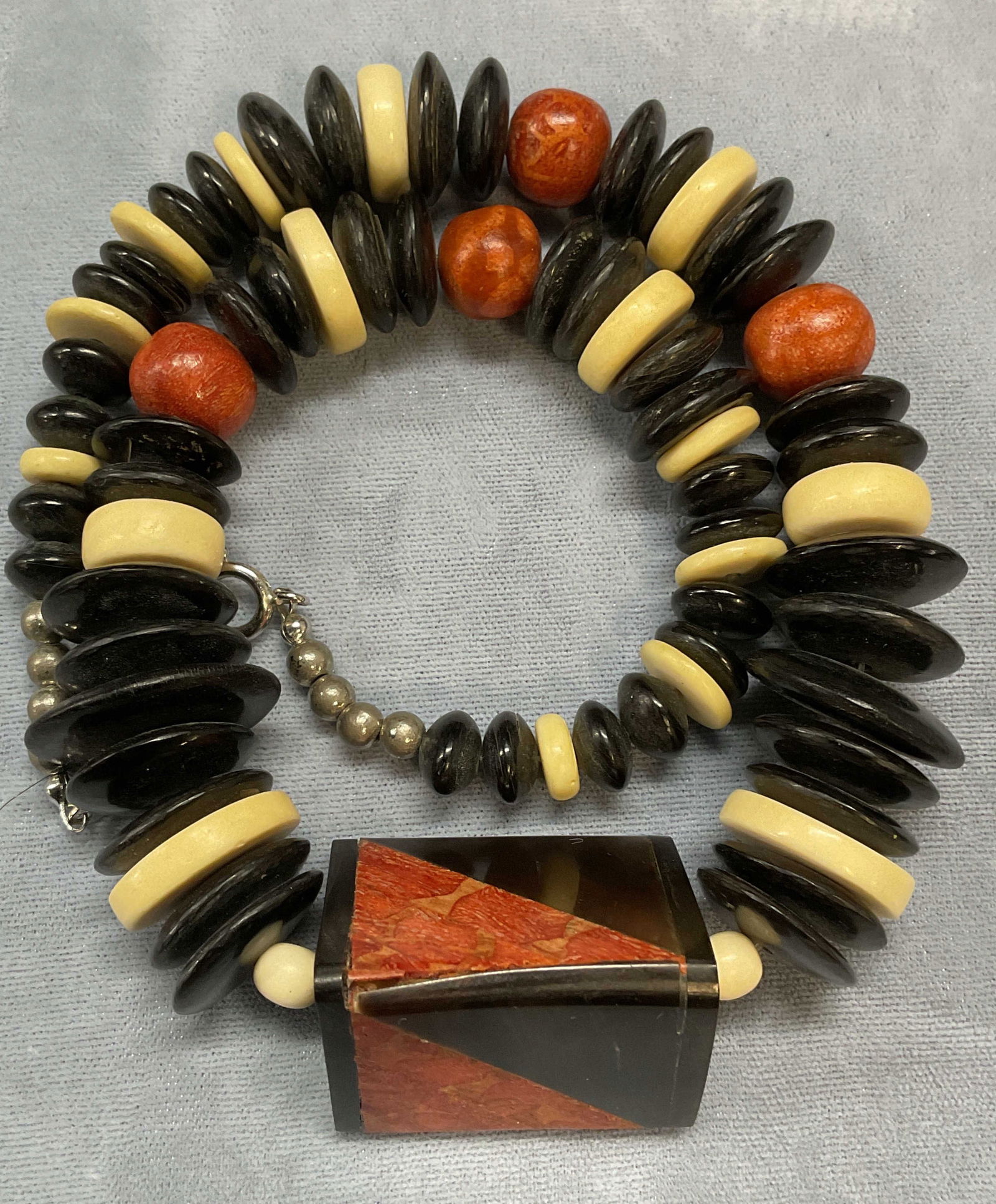 Bone, Horn, Coral Beaded Necklace: Beaded necklace with bone, horn, and coral. Possibly faux materials. Drop length approx. 8 inches. Some surface wear including scratching separation observed. Jewelry, estate jewelry, costume jewelry,