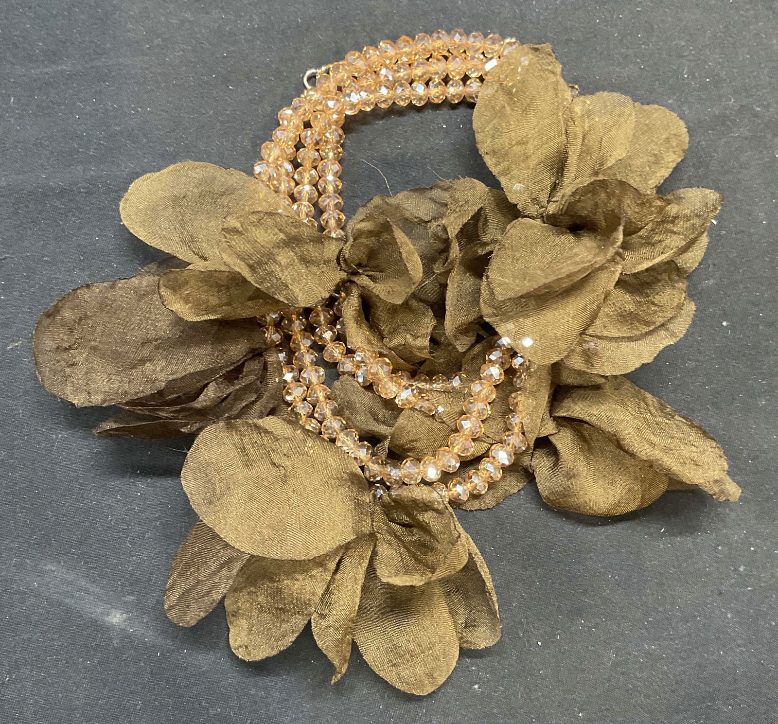 Vintage Amber Crystal Green Flower Necklace: Vintage amber tone crystal beaded necklace with green faux flower decoration. Drop length approx. 20.5 inches. Some surface wear including scratching observed. Jewelry, estate jewelry, costume jewelry