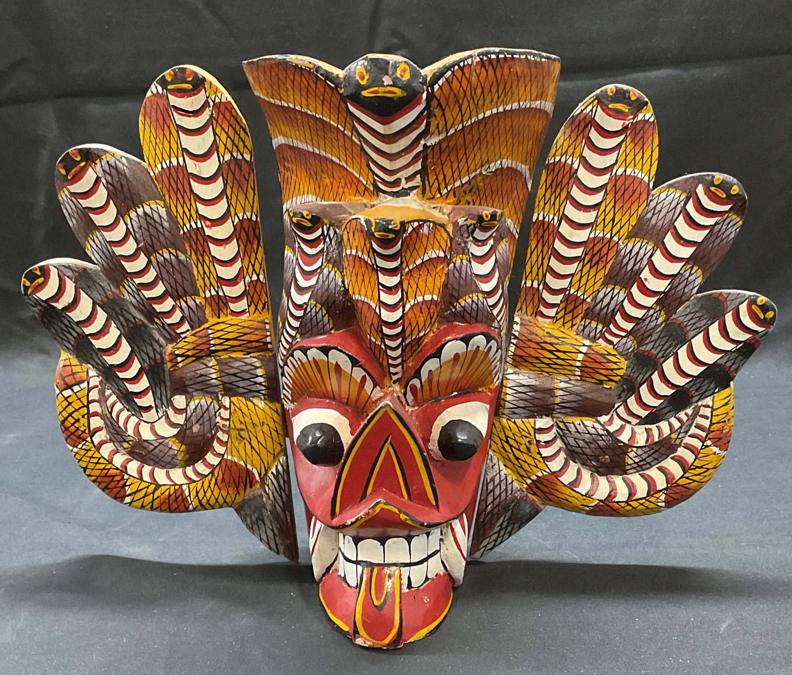 Vintage Wood Naga Raksha Cobra Mask: Vintage hand carved wooden Naga Raksha mask. Cobra mask. Traditional Sri Lankan style mask. Hand painted. Measures approx. 10.5 x 3.5 x 8 inches. Some surface wear including loss to paint observed. Na