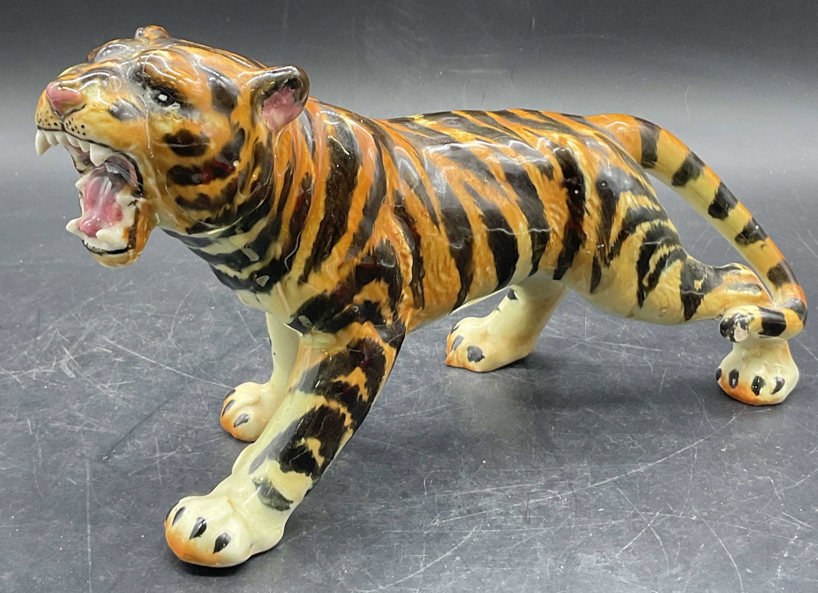 Trademarked Vintage Hand Painted Tiger Figural: A vintage hand painted ceramic tiger figural. Underside trademarked and reads Occupied Japan. Measures approx. 5H x 9W in. Measured at widest point. Repairs present. Crazing and chipping. home decor, 