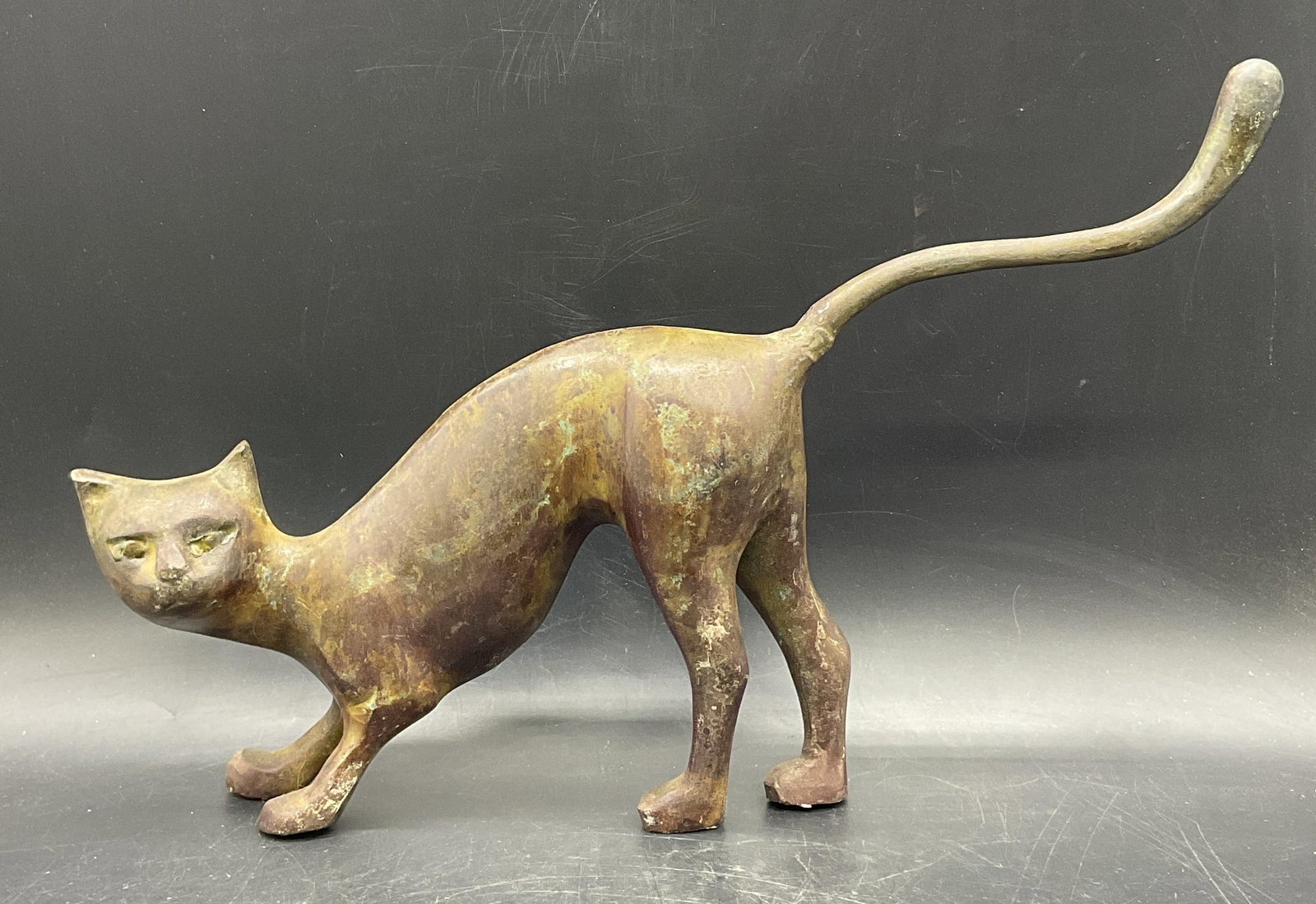 Vintage MCM Acid Wash Bronze Cat Figural: A vintage mid century modern acid wash bronze cat figural. The piece is crafted from metal, appears to be bronze, and has an acid wash finish. Measures approx. 9.75H x 15W in. Measures at widest point