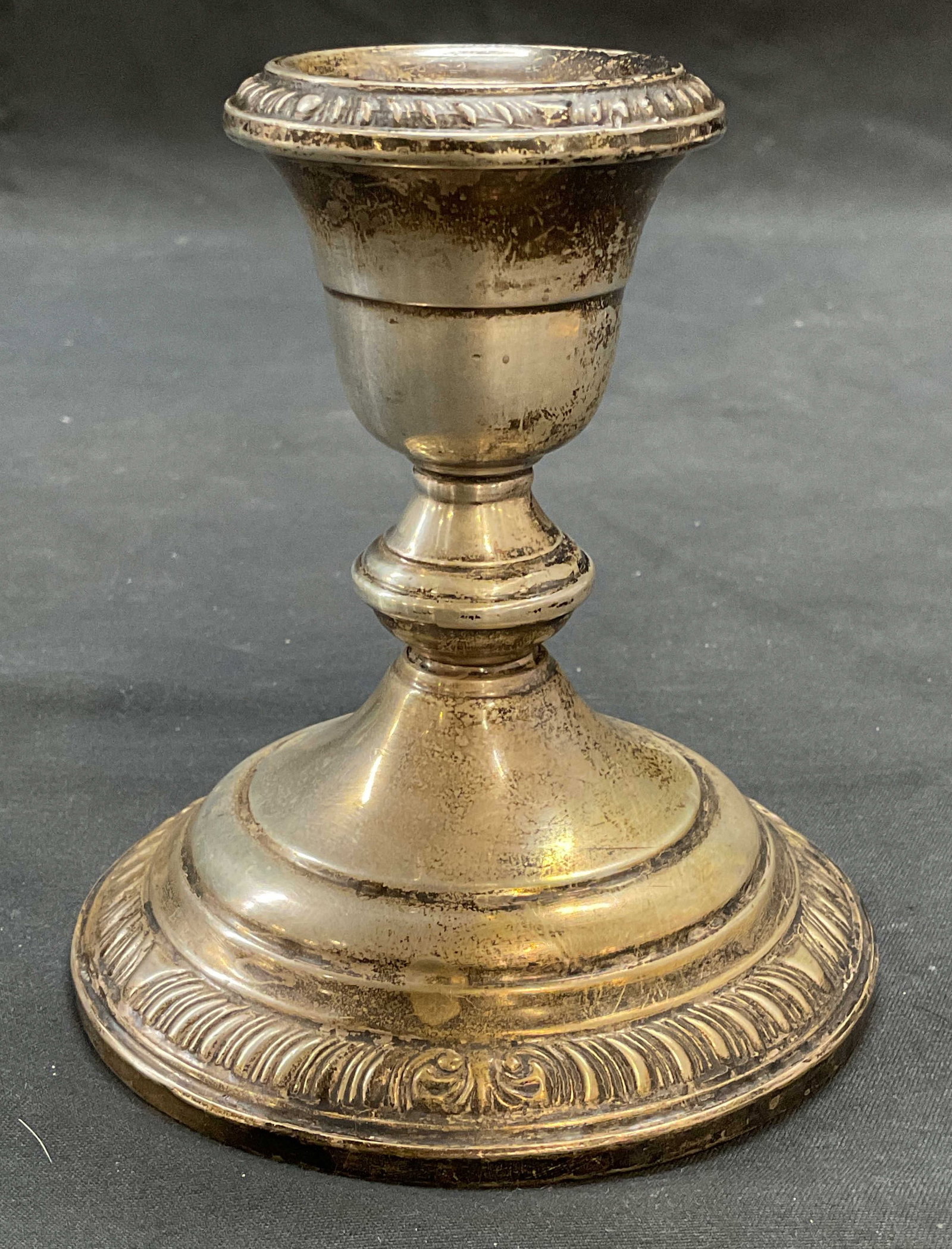 Vintage Anston Sterling Silver Candle Holder: Vintage Anston Sterling silver candle holder with raised scroll pattern on borders. Hallmarked on undersides. Measures approx. 3.75 x 4 inches. Marked sterling, reinforced. Total weight 386.7 grams. S