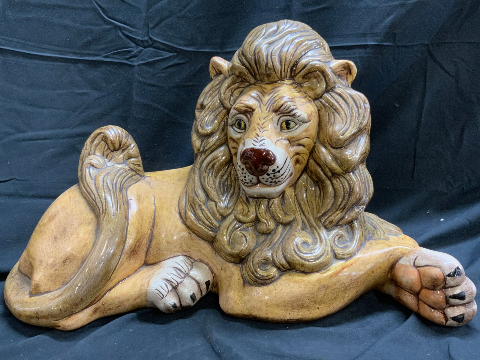 Vintage Ceramic Guardian Lion Statuary: Lion statuary is vintage. Piece appears to be ceramic possibly porcelain. Figure depicts a laying guardian lion figure. Piece appears to possibly be hand painted. Piece has facial features, mane, & pa