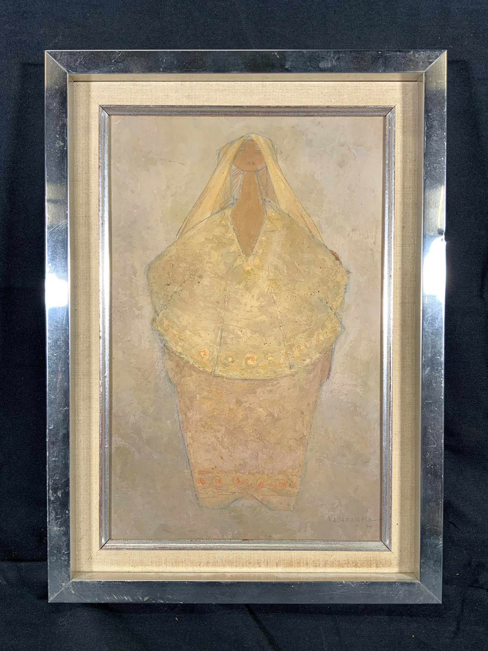 Signed Vntg Woman with Veil Oil Painting 1974: Oil painting on board. Signed in lower right corner. Signature reads Valenzuela. Dated 1974. Subject depicts a woman standing with a simple patterned shirt and skirt on, she has a veil on her head tha