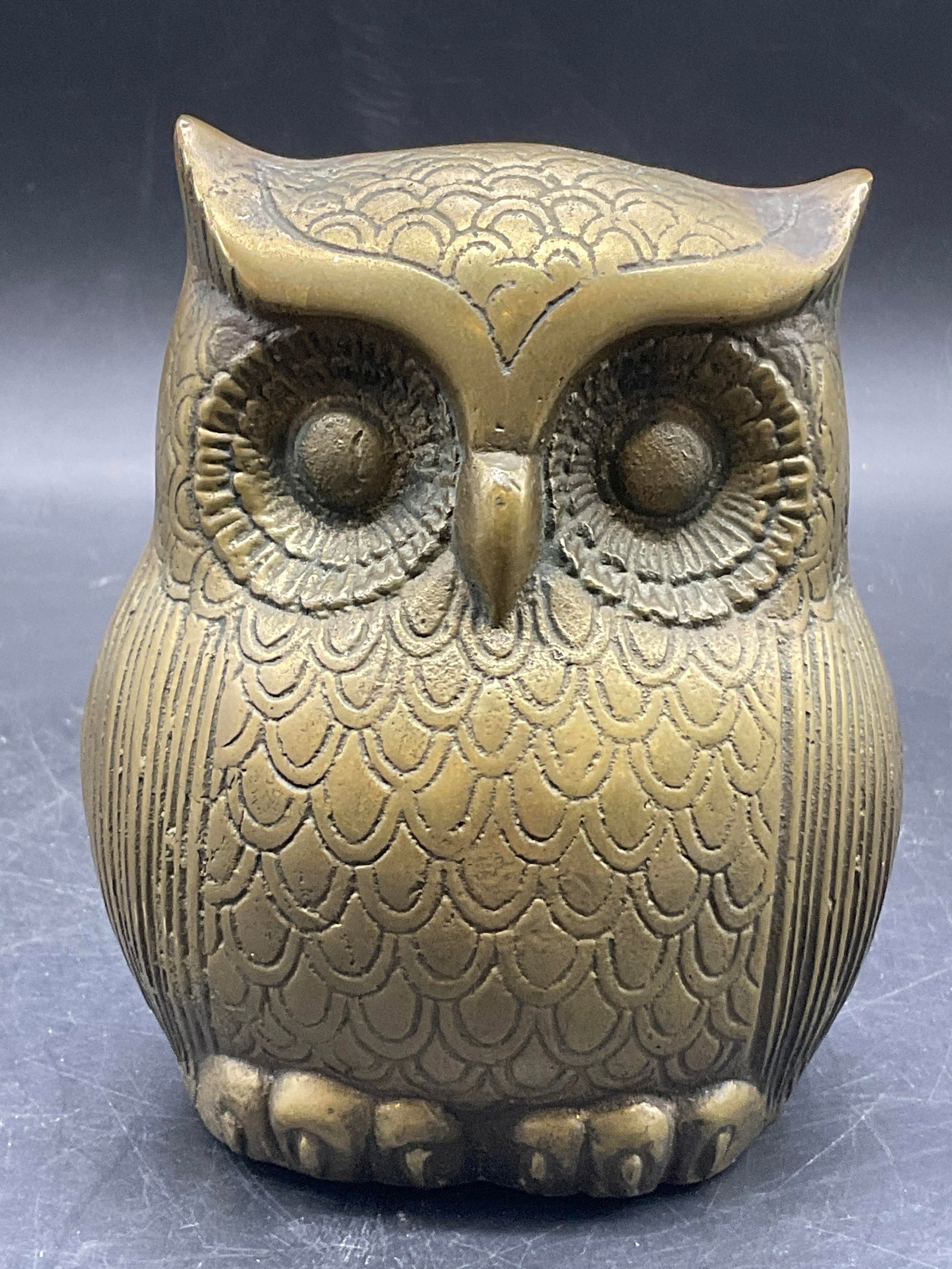 Vintage Brass Owl Coin Bank Korea: A vintage brass owl coin bank. Stopper to the underside. Sticker to the underside reads MADE IN KOREA. Measures approx. 5H x 3.5W in. Discoloration and surface wear present. Sticker residue to undersi