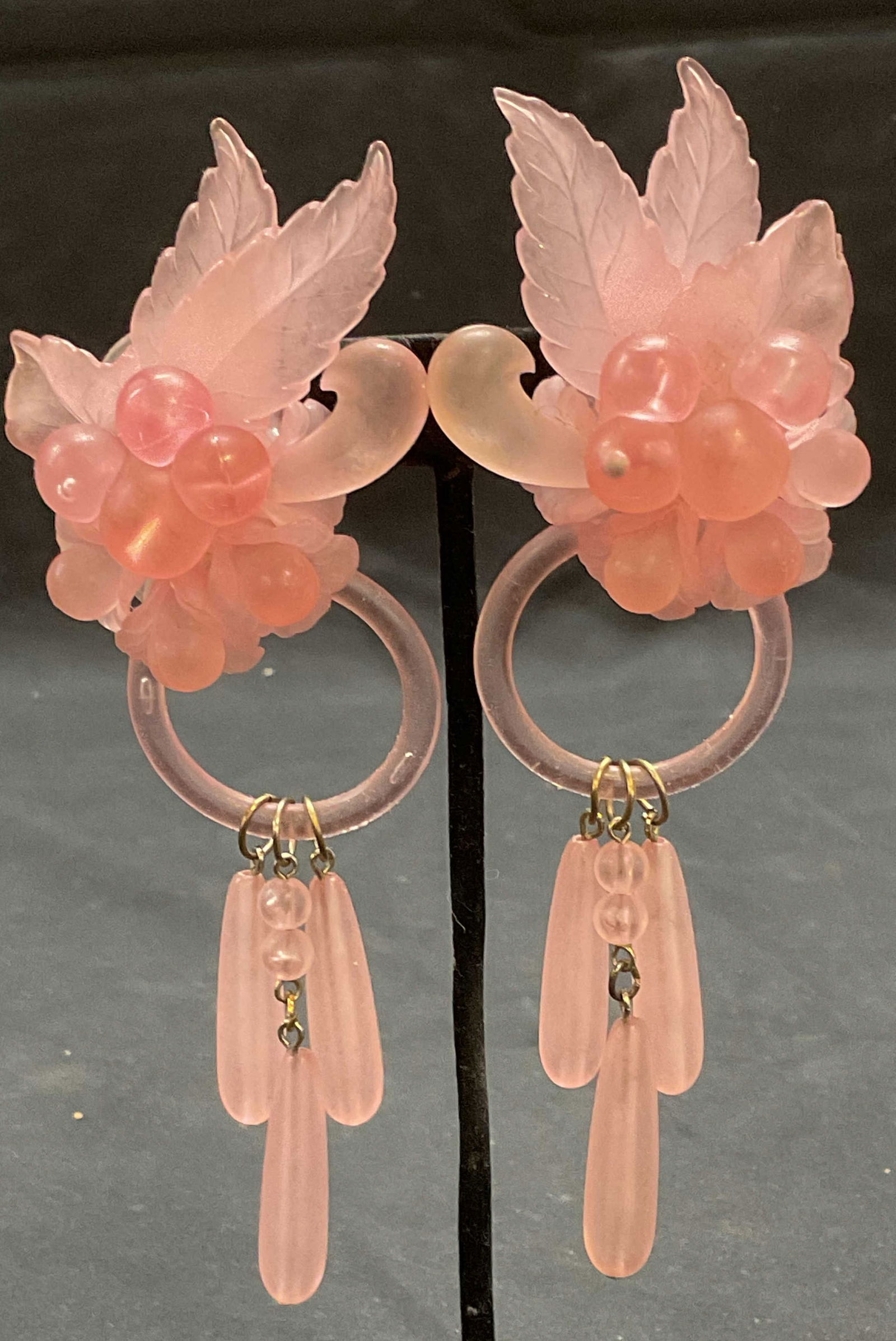 Vintage Pink Lucite Flower Earrings, 5.25 In L: Vintage pink lucite dangle clip on earrings with floral motif. Measure approx. 5.25 x 1.75 inches. Some surface wear including scratching observed. Jewelry, estate jewelry, costume jewelry, cocktail j