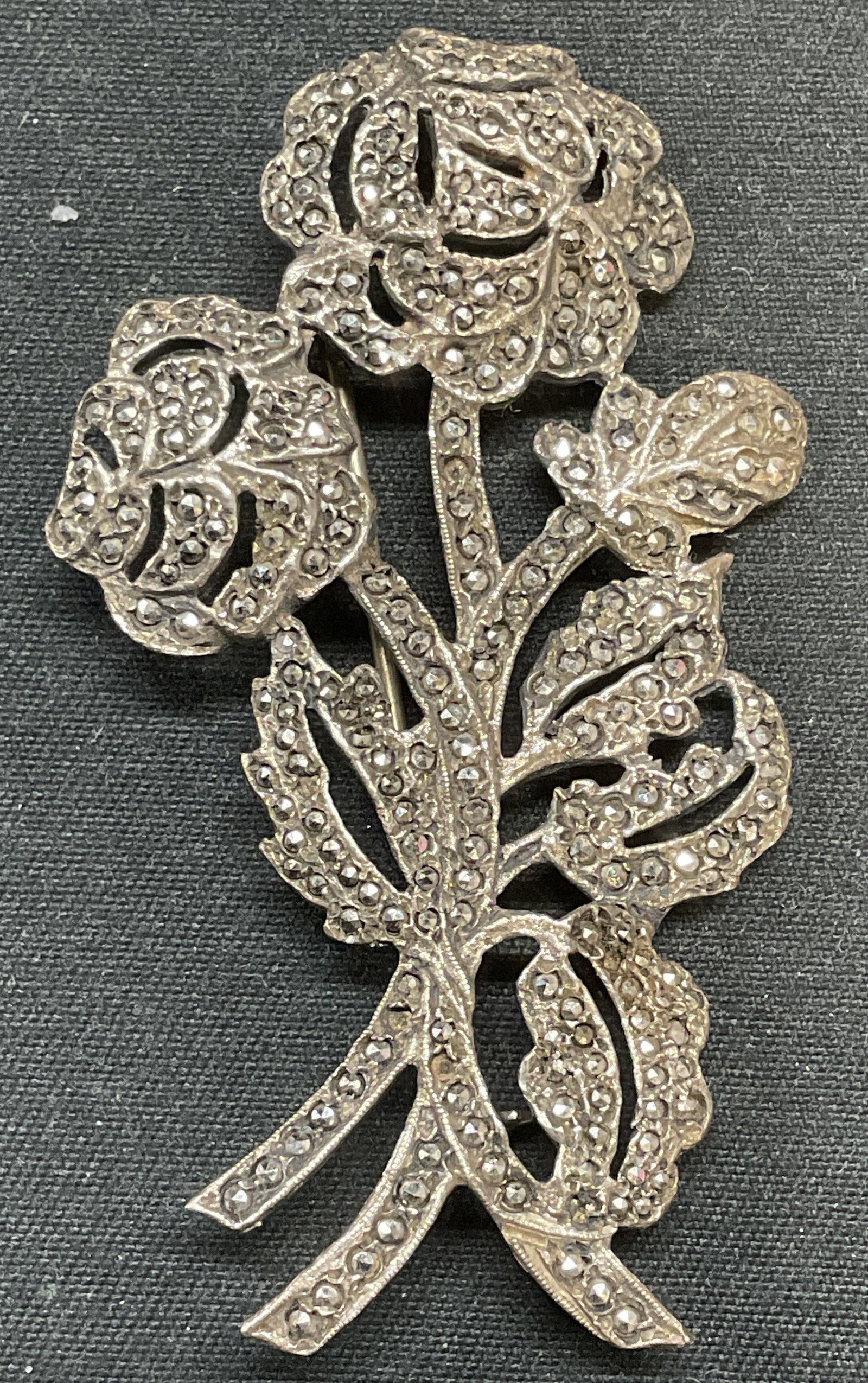 Vtg Sterling Silver Marcasite Rose Flower Brooch: Vintage sterling silver and marcasite rose flower motif brooch. Marked sterling. Hinge pin on underside. Measures approx. 2.25 x 1.25 inches. Total weight 10.2 grams. Some surface wear including scrat
