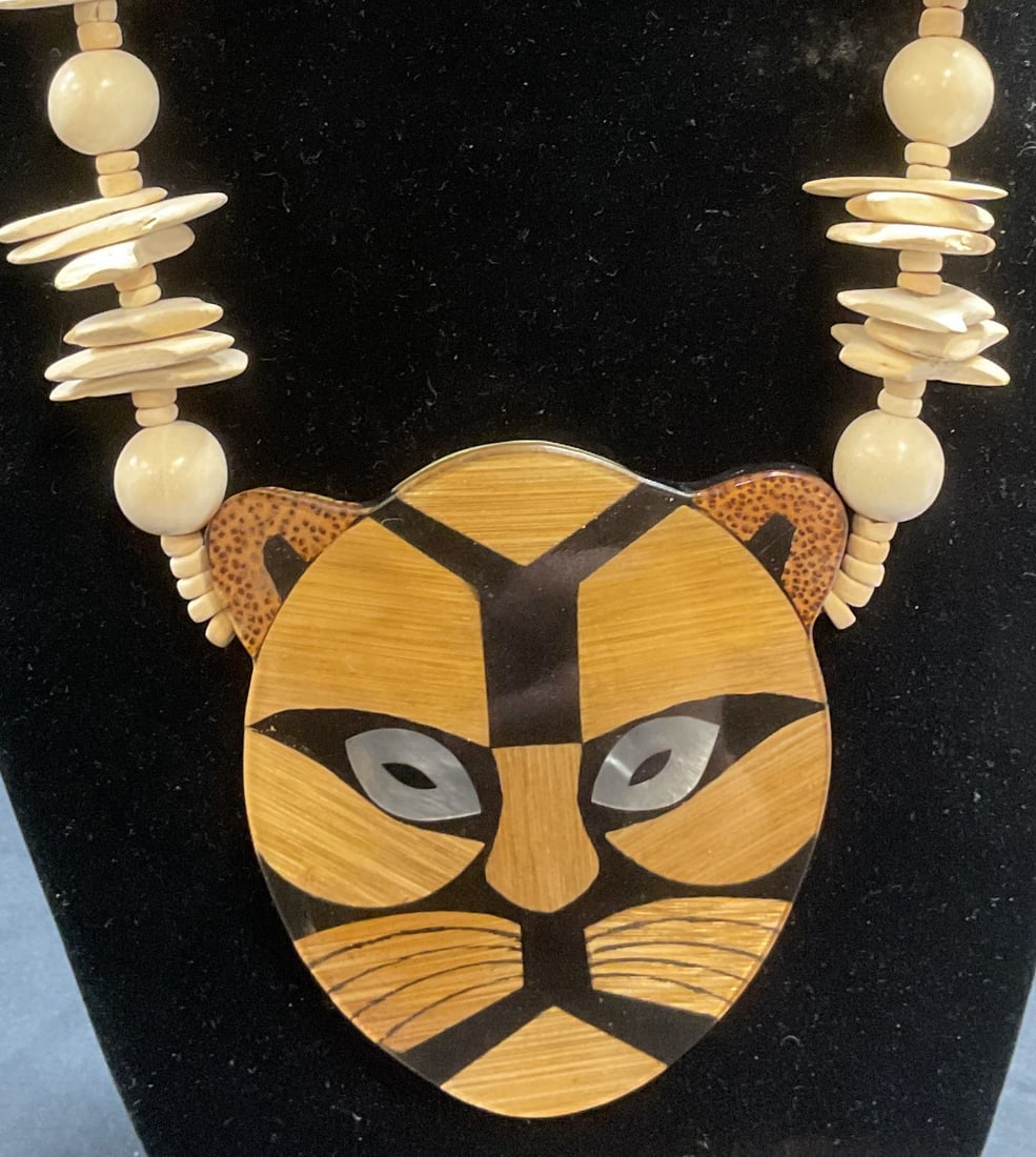 Vintage Beaded Leopard Pendant Necklace: Beaded pendant necklace. Resin coated leopard head pendant with inlaid mother of pearl and other natural materials. Beaded strands, appear to be bone. Style of Lee Sands, no Signature observed. Drop l