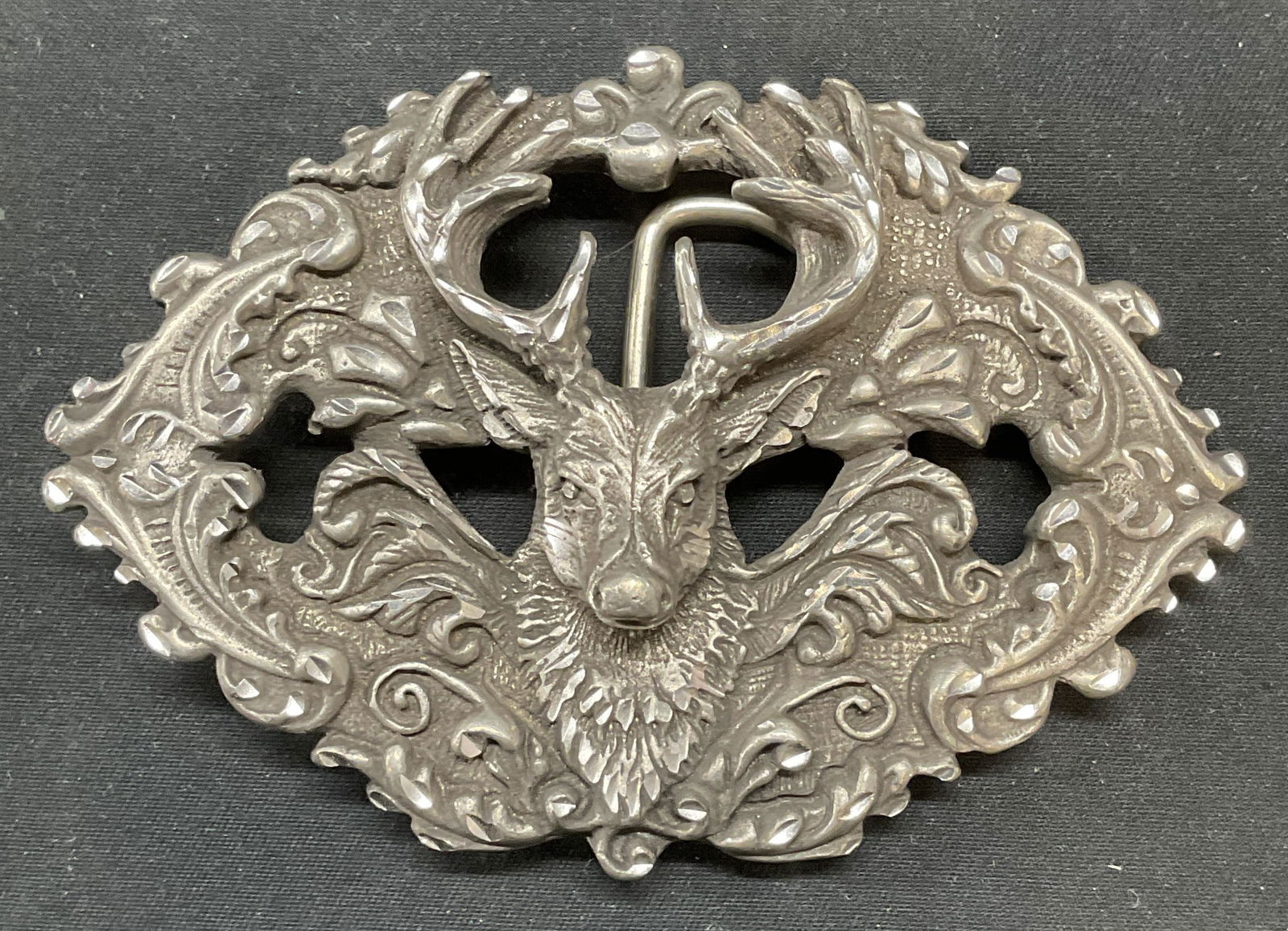 Vintage EJC Pewter Buck Deer Belt Buckle USA: Vintage 1995 EJC pewter buck deer motif belt buckle with pierced design and raised scroll pattern. Signed on underside. Made in USA. Measures approx. 3.75 x 2.5 inches. Some surface wear consistent wi