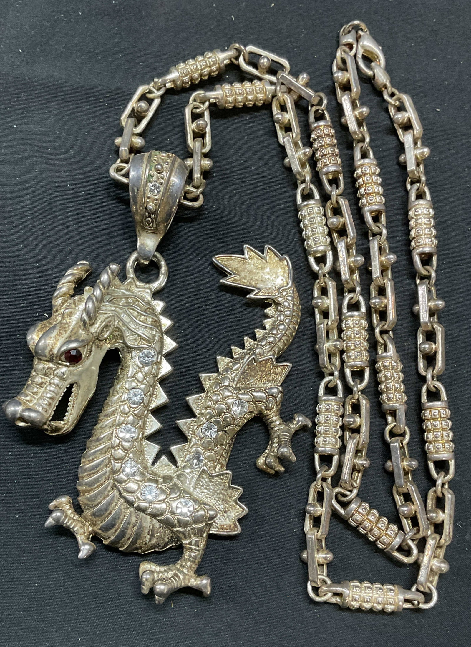 Vintage Silver Tn Crystal Dragon Pendant Necklace: Vintage silver tone granulated chain necklace with silver tone dragon motif pendant and crystal decoration. Drop length approx. 14 inches. Pendant measures approx. 4 x 3 inches. Piece has weight. Some
