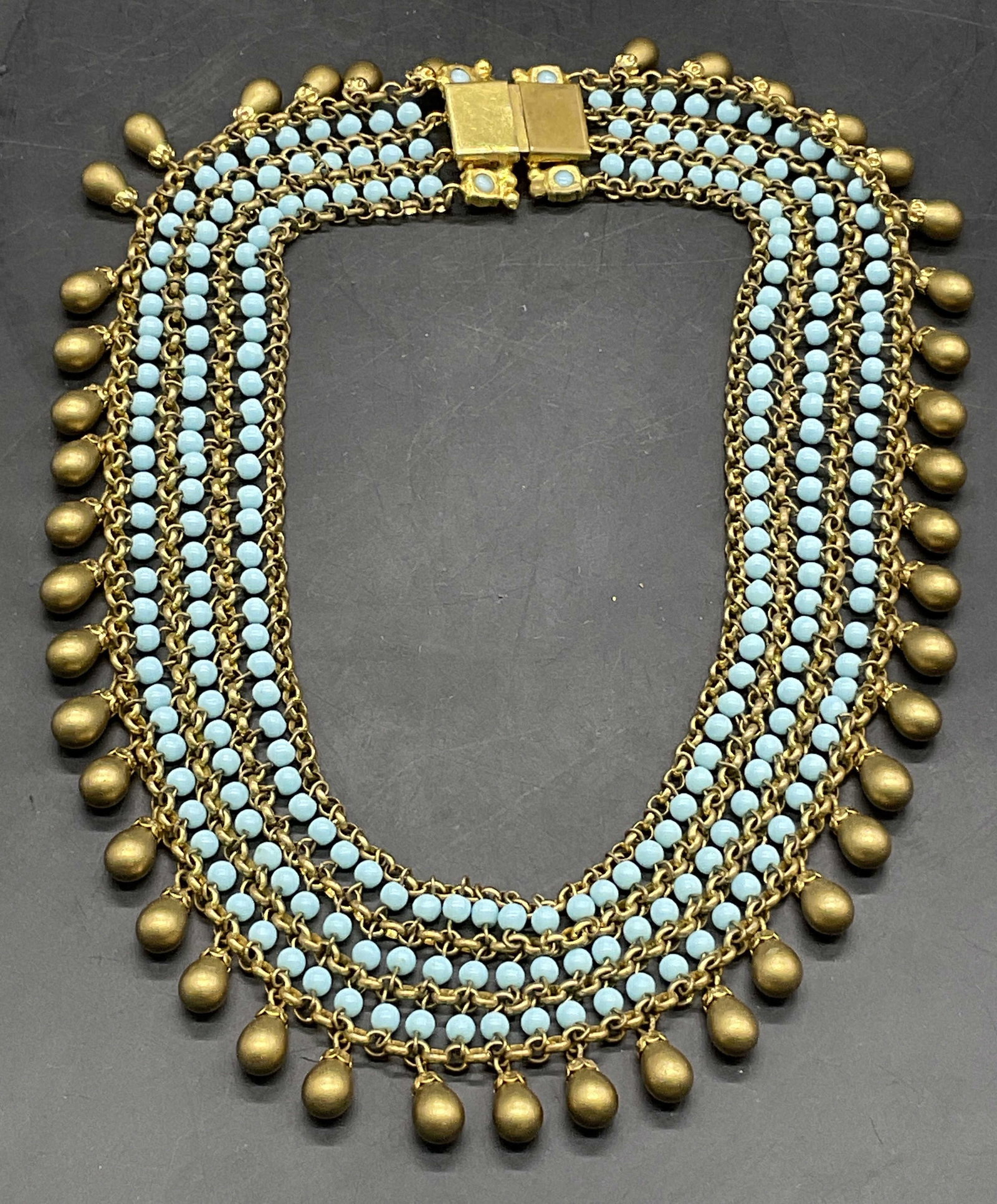 Turquoise Style Beaded Choker Necklace: A beaded gold tone metal chain choker necklace featuring costume turquoise beads and gold tone beads. Box clasp closure. Necklace length measured end to end approx. 16 inches. Surface wear consistent 