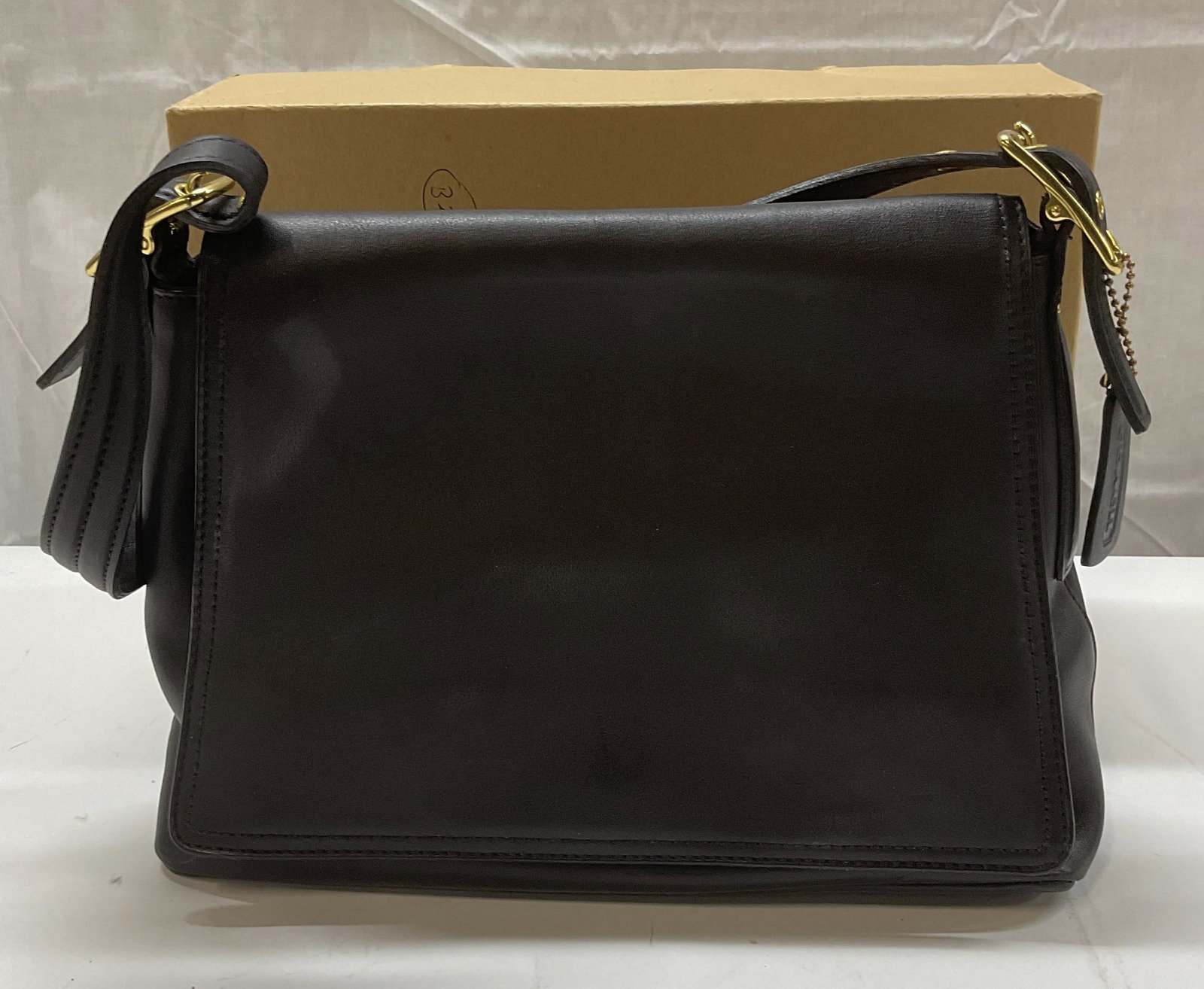 Coach Legacy West Clack Leather Handbag, Box: Coach Legacy West black leather handbag. Fold over flap, zipper and slip pockets on interior. Signed on hang tag and interior creed. Serial number J1P 9828. Measures approx. 11.5 x 4.5 x 8 inches. Inc