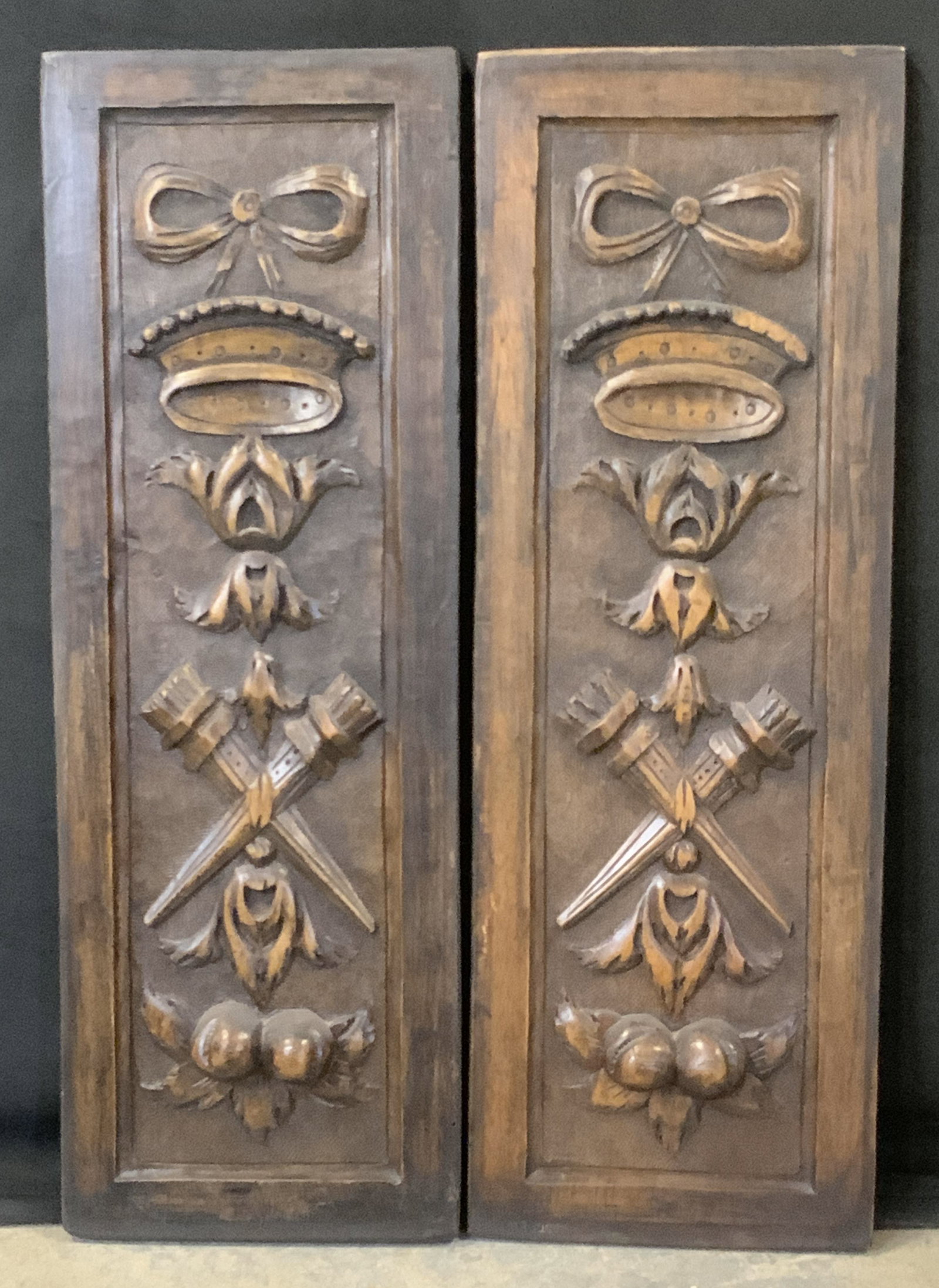Pair Vintage Wooden Wall Hangings: A pair of vintage wooden wall hangings. Pieces feature raised woodwork designs to the obverse. Measures approx. 24L x 8.5W in. Chipping present. Some surface wear consistent with age, use, and exposur