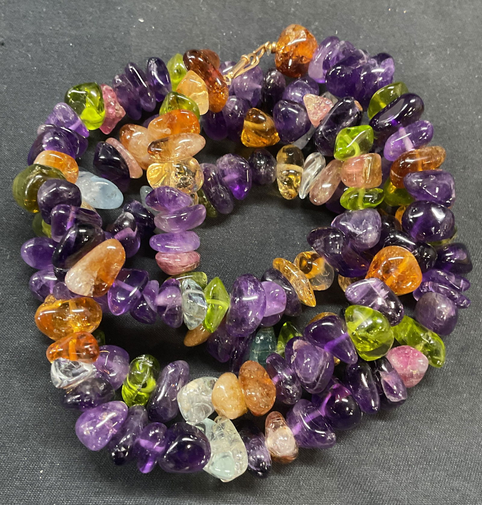 Amethyst Multicolor Semiprecious Stone Necklace: Amethyst and multicolor semiprecious stone beaded necklace. Drop length approx. 15 inches. Marked on clasp illegibly. Total weight 136.1 grams. Some surface wear including scratching observed. Jewelry