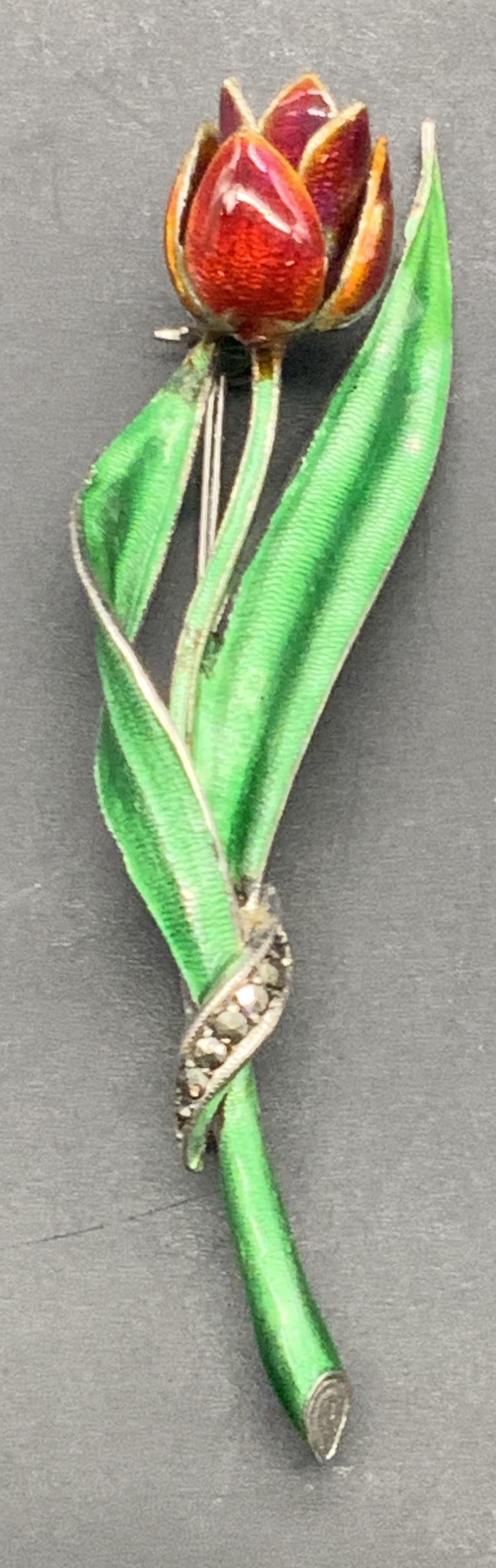 Vntg 835 Silver Marcasite & Enamel Rose Brooch: A vintage 835 silver red and green enameled rose brooch featuring marcasite towards the base. Metal pin closure to reverse. Measures approx. 2.75L x .75W in. Total weight .31 ozt. Some losses to ename