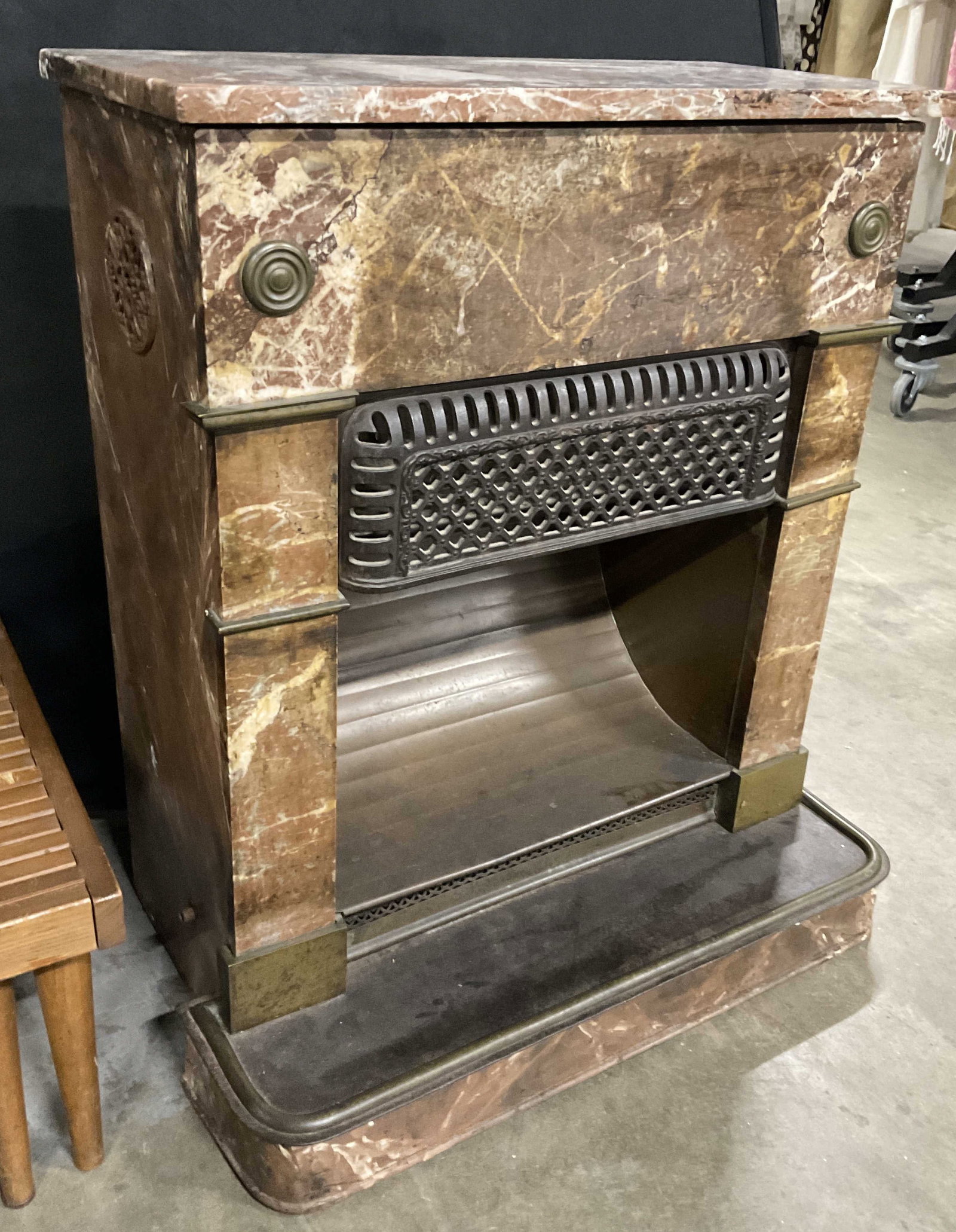 Vintage Marble & Iron Fireplace: A vintage fireplace crafted from marble, iron, and metal materials. Some parts of the metal are painted to resemble stone. The top is removable. Measures approx. 32H x 12.25D x 26.5W in. Not tested fo