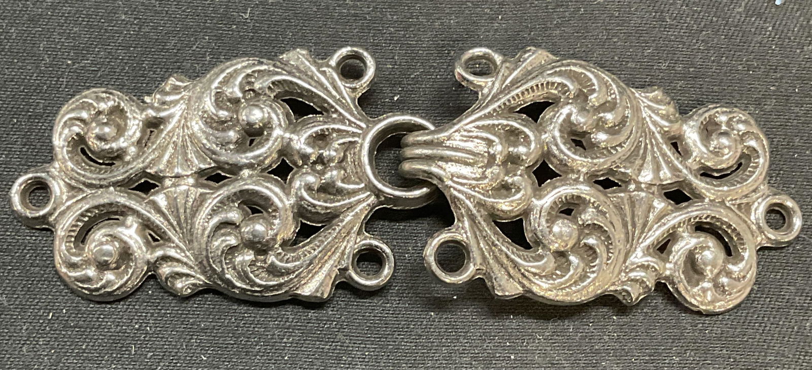 Vintage Tinn Per Norway Pewter Scroll Clasp: Vintage Tinn Per Norway pewter pierced scroll motif hook clasp or buckle. For jewelry making, capes, cloaks, sweaters, or other craft. Signed on undersides. Pieces measure approx. 1.5 x 1 inches each.