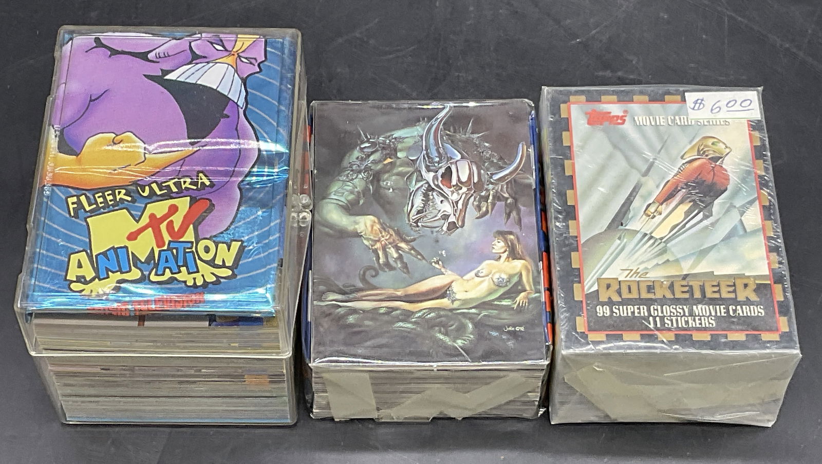 Grp Lot Collectible Trading Cards, HEAVY METAL +: A group lot of collectible trading cards. The group includes HEAVY METAL, FLEER ULTRA TV ANIMATION, and THE ROCKETEER. One group of cards is contained in a hard plastic case which measures approx. 2.7