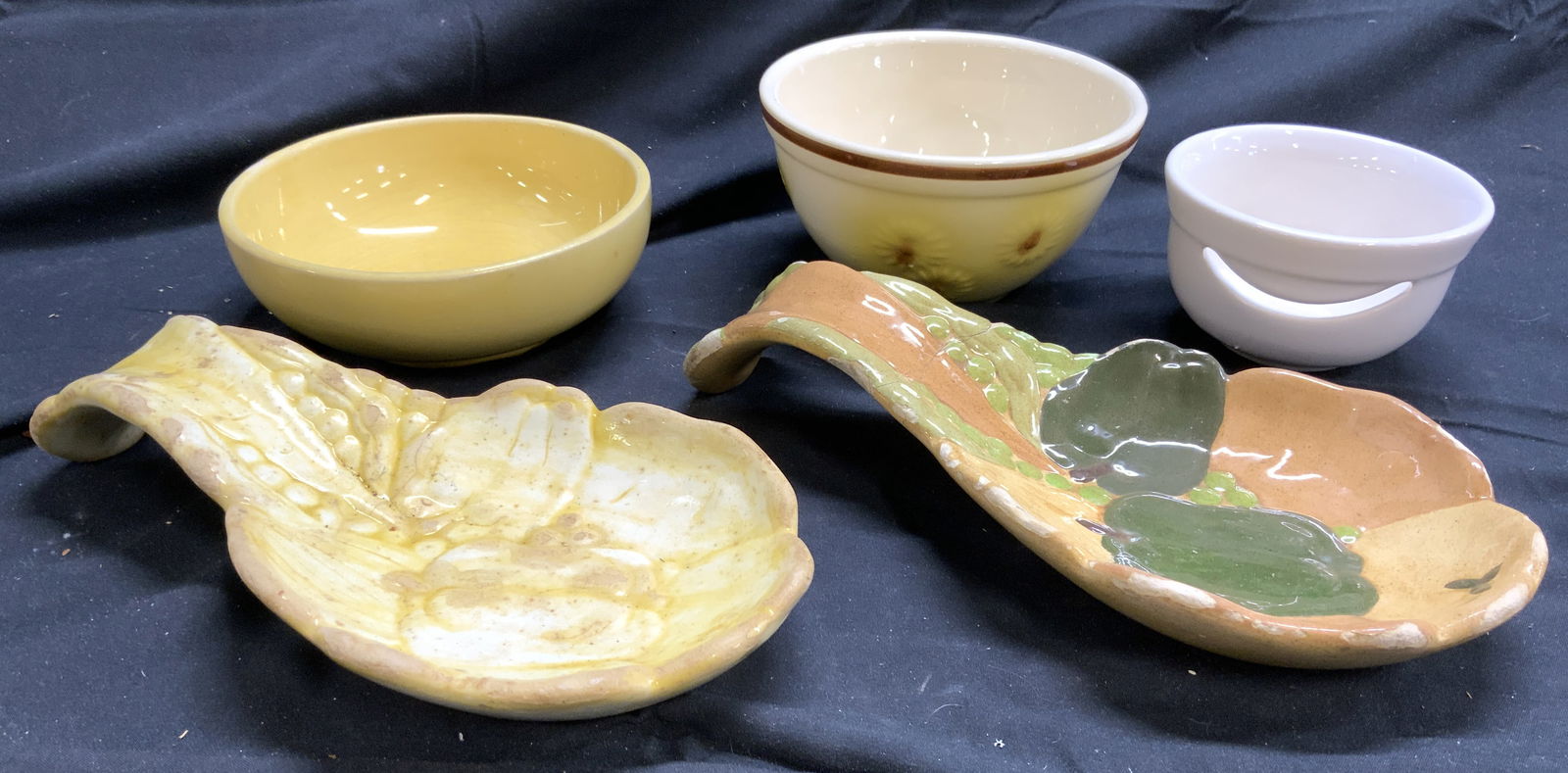 Lot 5 Porc Bowls & Ceramic Utensil Holders: Undersides of 1 serving utensil holder read CERAMICS BY PHYLLIS. Underside of floral detailed plate reads HULL. Underside of yellow bowl reads MCCOY. Lot includes 3 porcelain bowls & 2 Ceramic serving