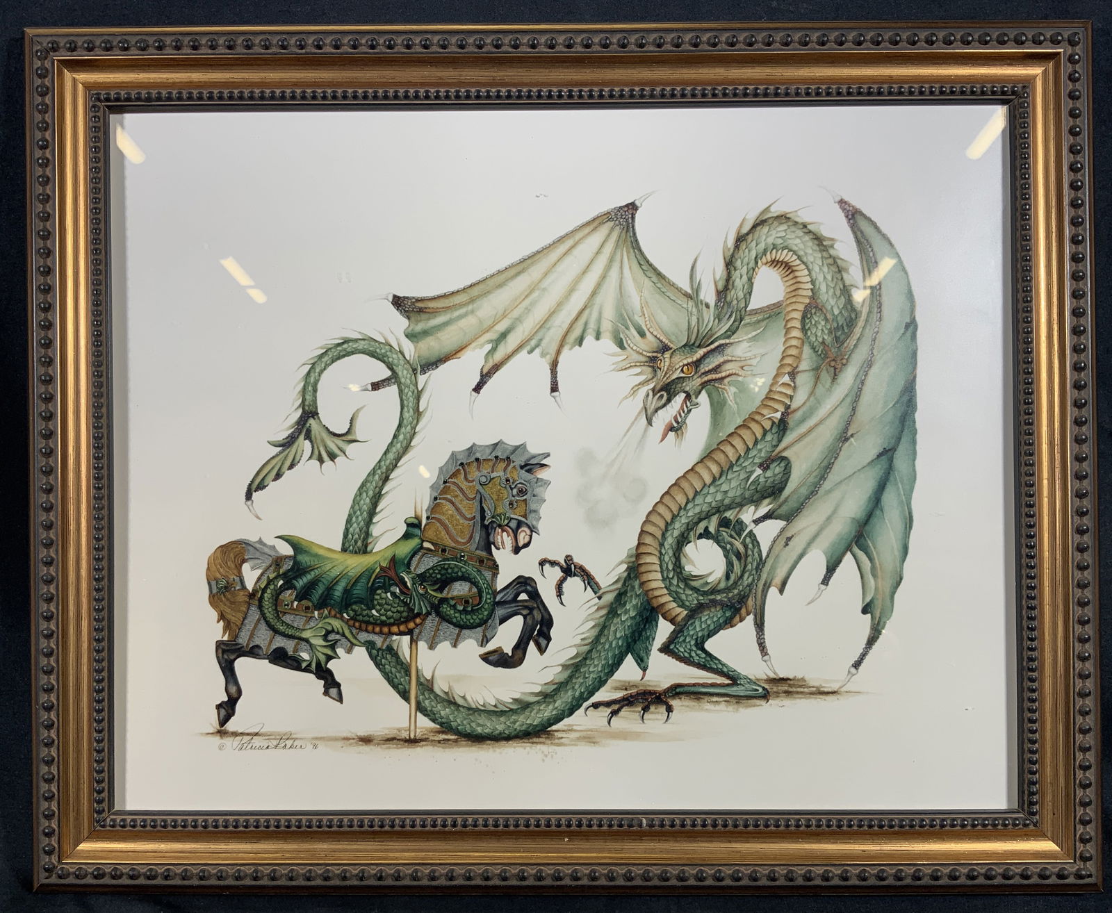Framed Patricia Baber The Dragon Slayer Lithograph: Lithograph on paper. Subject depicts a three eyed horse in full armor fighting a dragon. Framed in a gilt wooden frame with a beaded motif. Frame measures approx. 16 W x 13 H in. Window measures appro