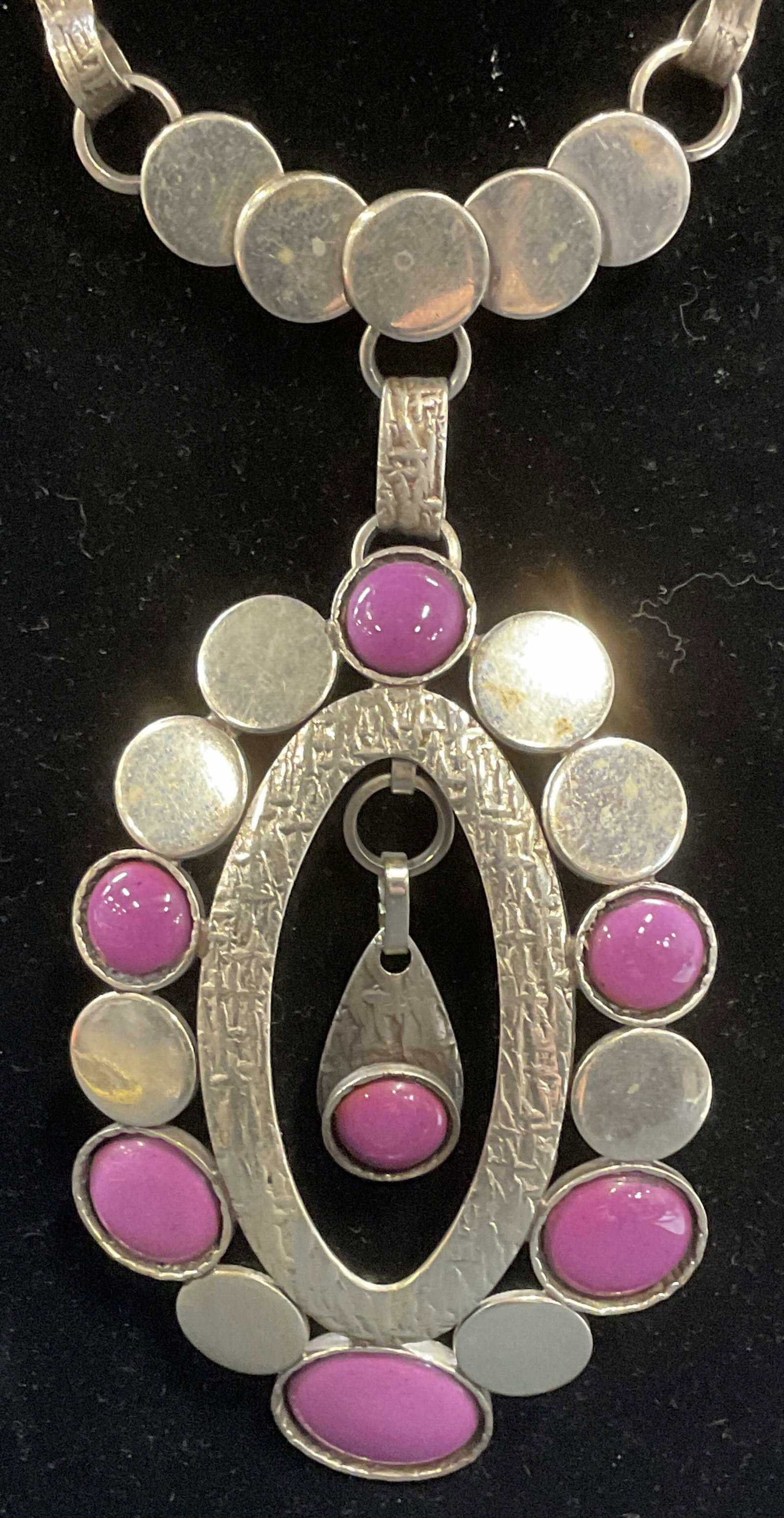 Vintage Silver tone Purple Pendant Necklace: Vintage silver tone pendant necklace with purple faux stone cabochons. Drop length approx. 11.5 inches. Pendant measures approx. 4.25 inches long. Some surface wear including scratching observed. Jewe